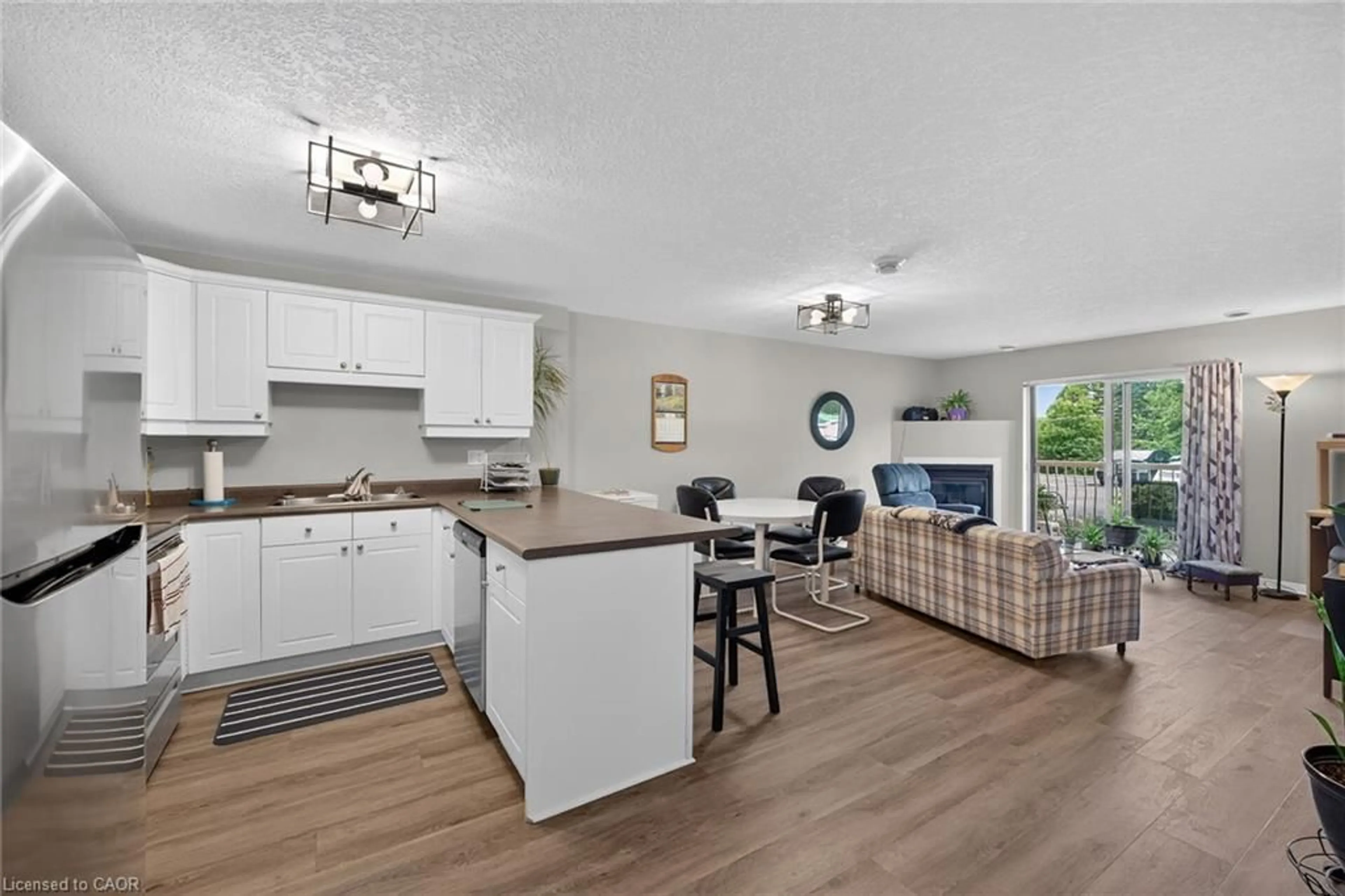 Open concept kitchen, wood/laminate floor for 12 St Andrew St #103, Port Dover Ontario N0A 1N1