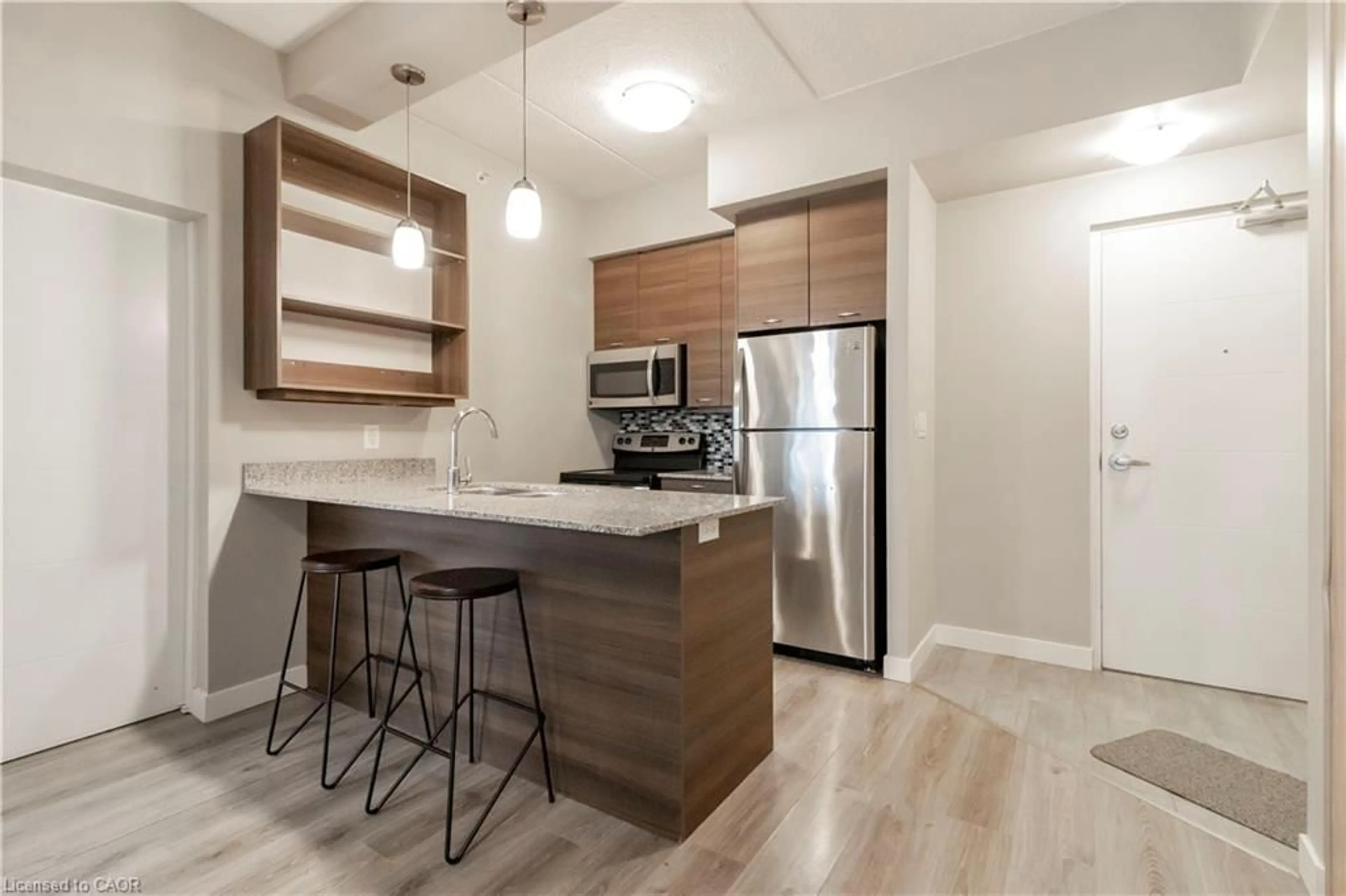 Open concept kitchen, wood/laminate floor for 318 Spruce St #1004, Waterloo Ontario N2L 0E9