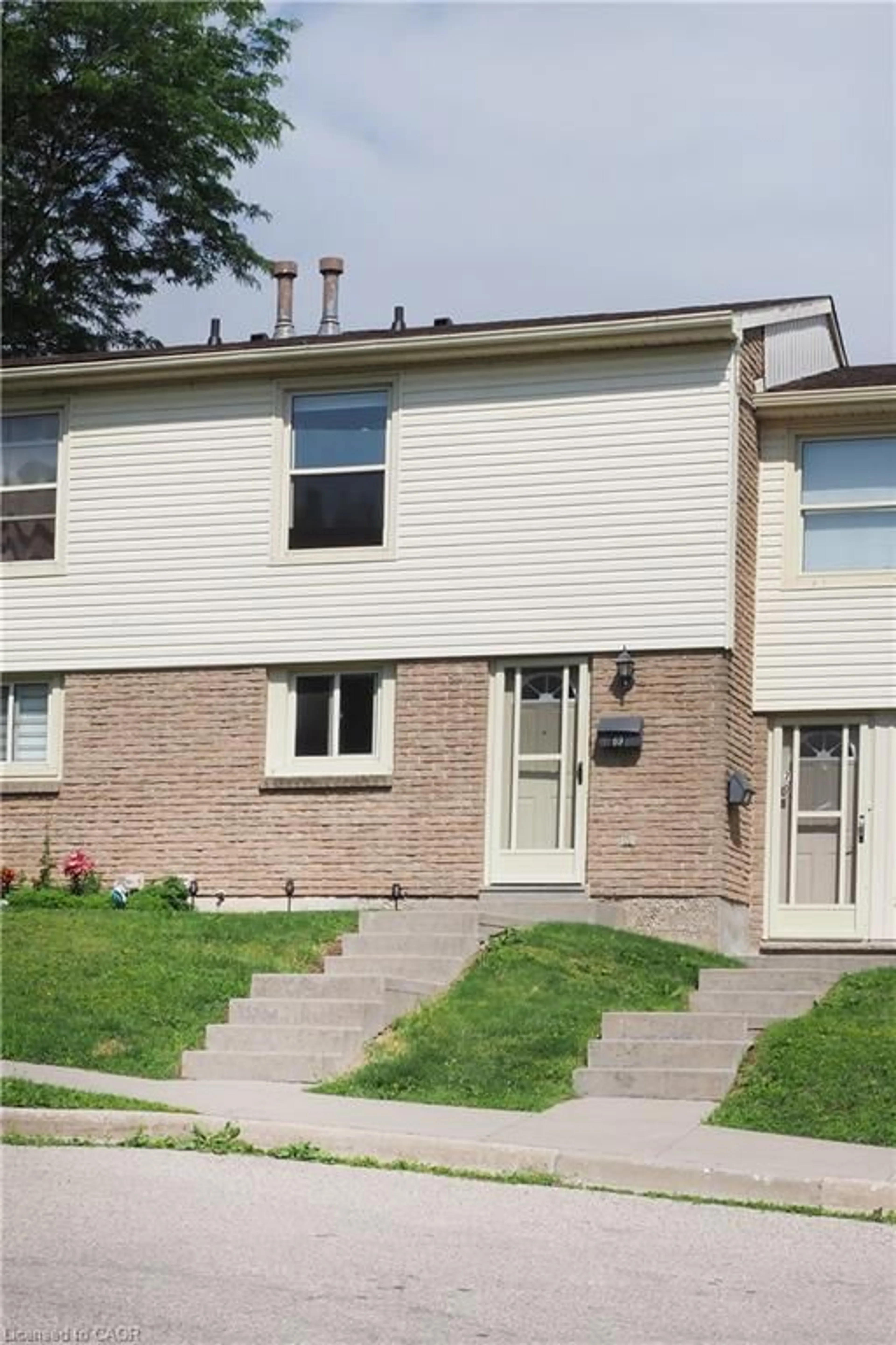 Home with brick exterior material, street for 165 Green Valley Dr #69, Kitchener Ontario N2P 1K3