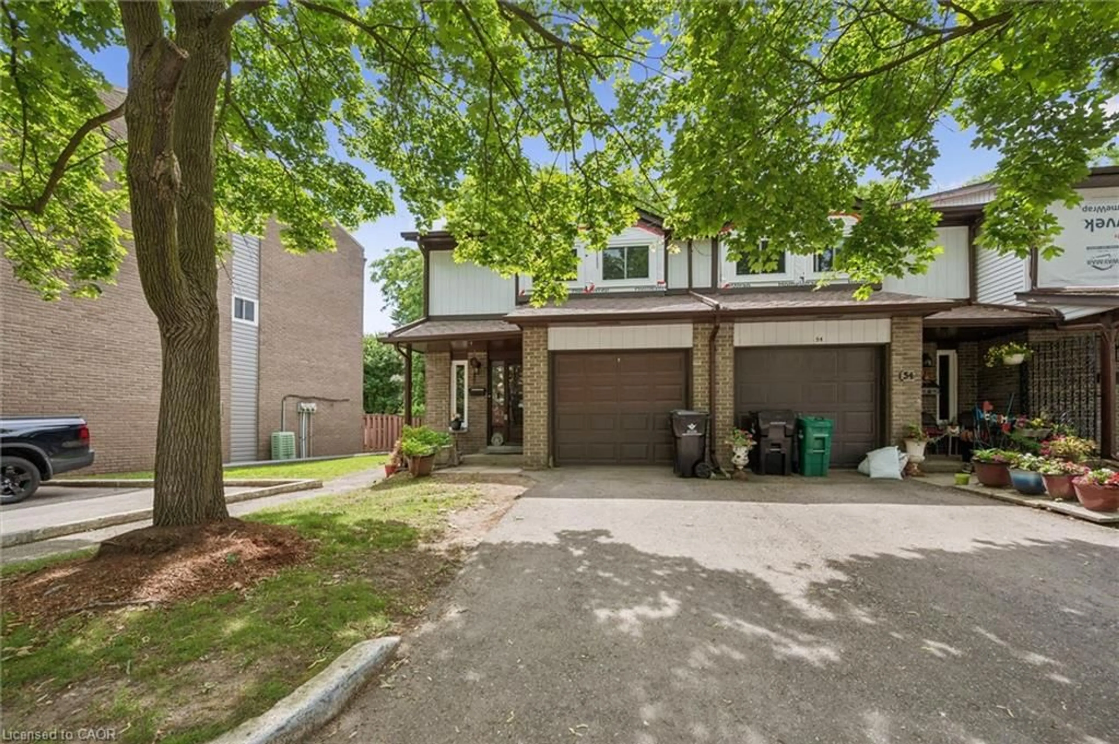 Home with brick exterior material, street for 46 Cedarwoods Cres #53, Kitchener Ontario N2C 2L7