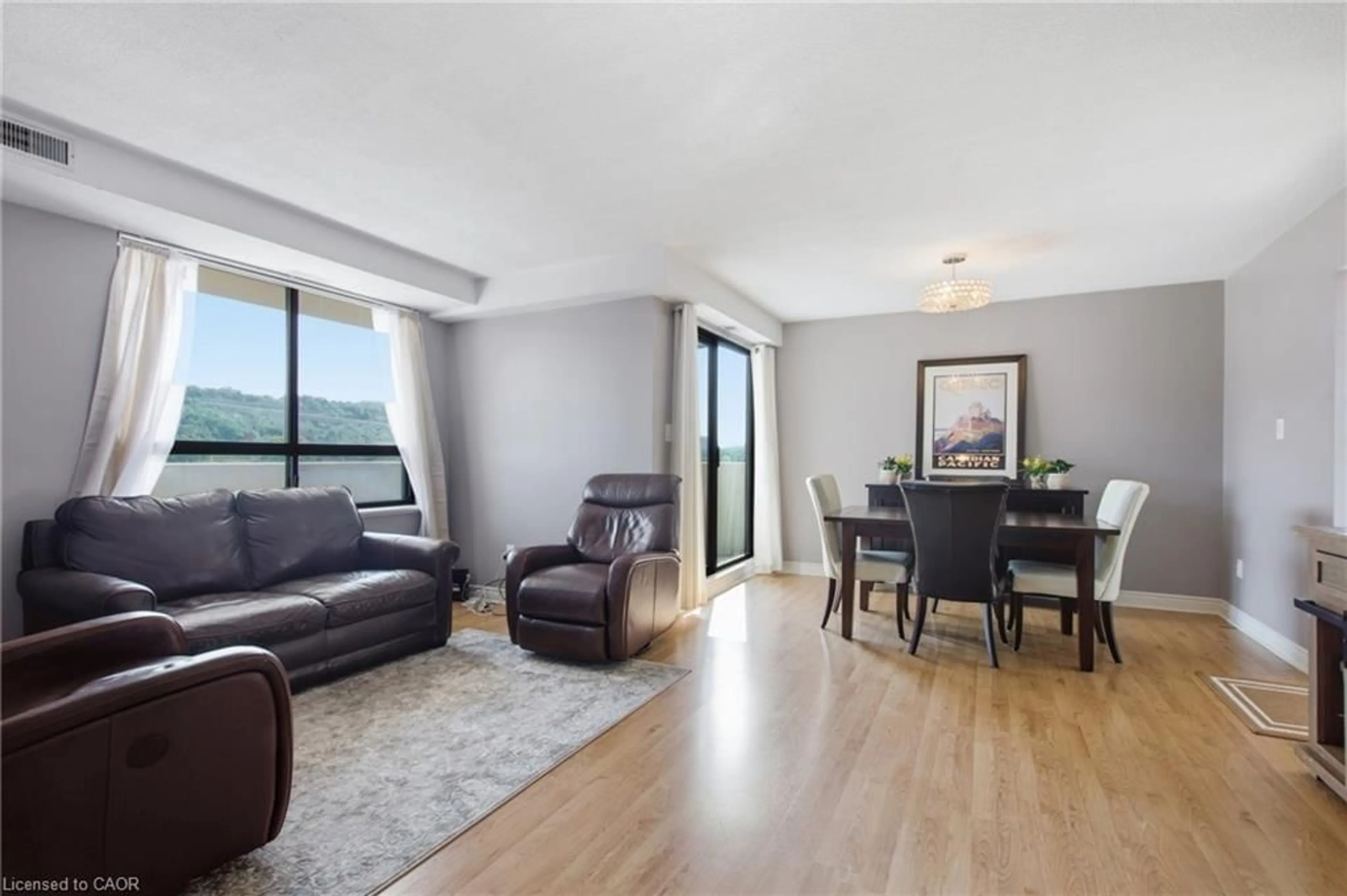 Living room with furniture, wood/laminate floor for 432 Main St #801, Hamilton Ontario L8N 1J9
