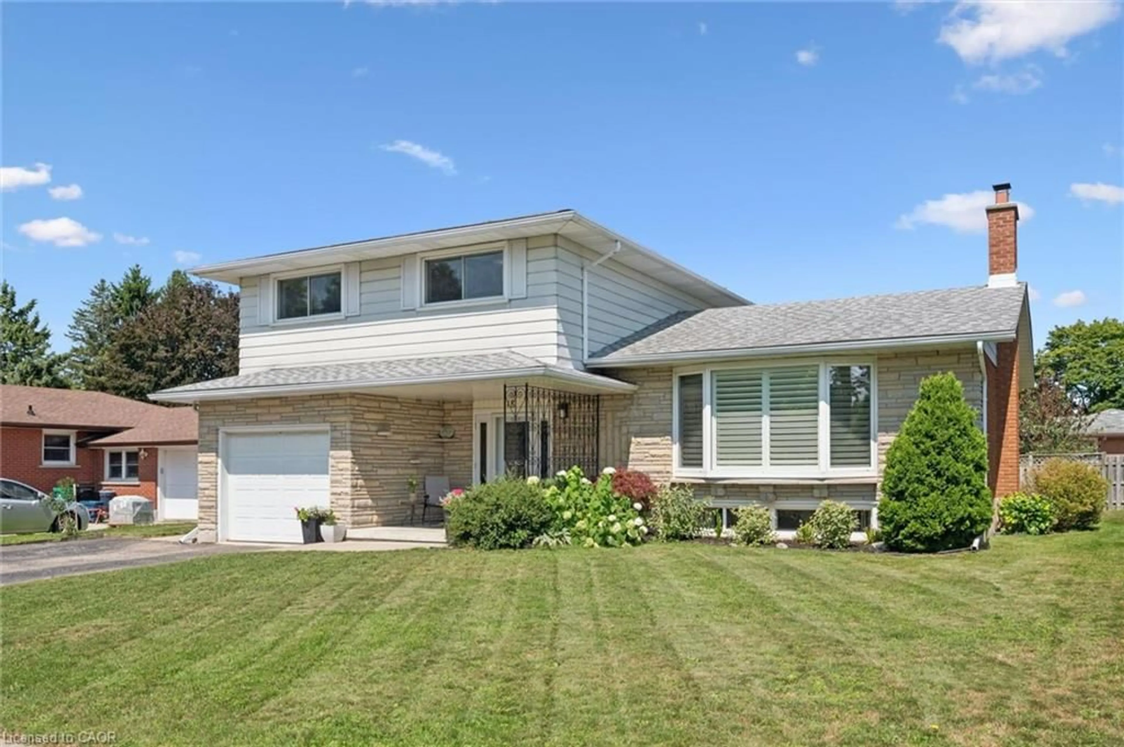 Home with vinyl exterior material, street for 18 Strathcona Cres, Kitchener Ontario N2B 2W6