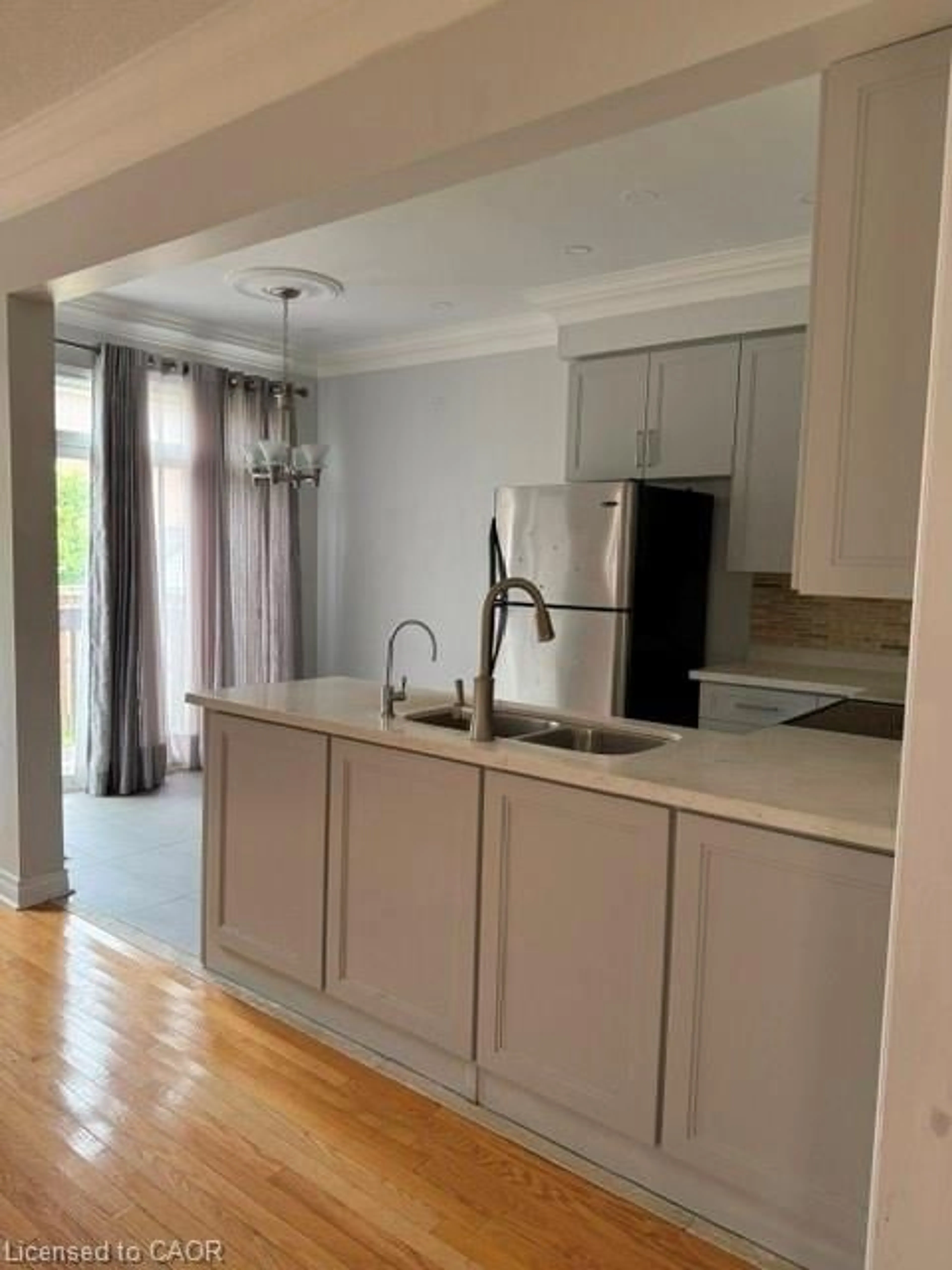 Open concept kitchen, wood/laminate floor for 27 Village Lake Cres, Peel Ontario L6S 6K2