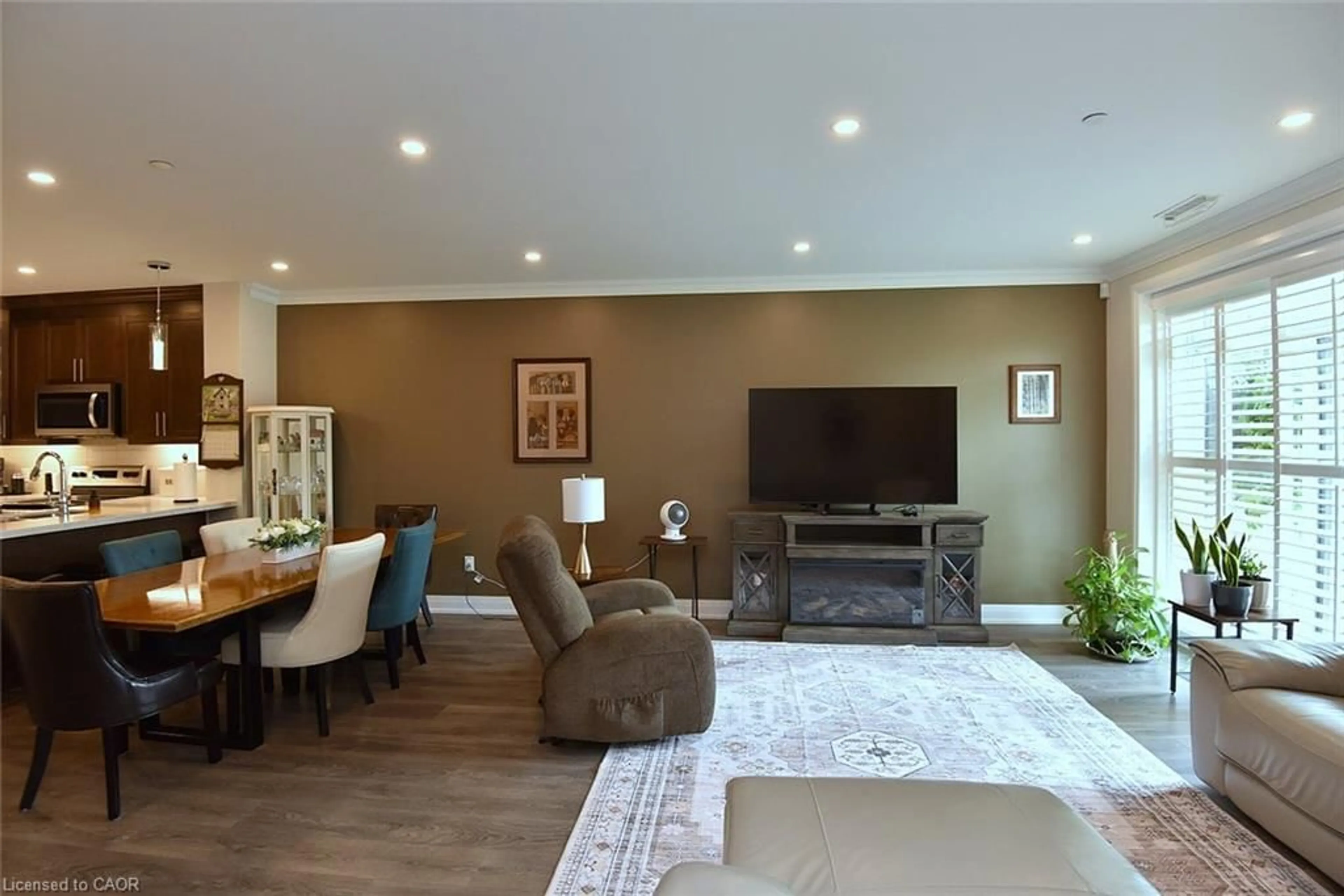Living room with furniture, wood/laminate floor for 830 Megson Terr #114, Milton Ontario L9T 9M7