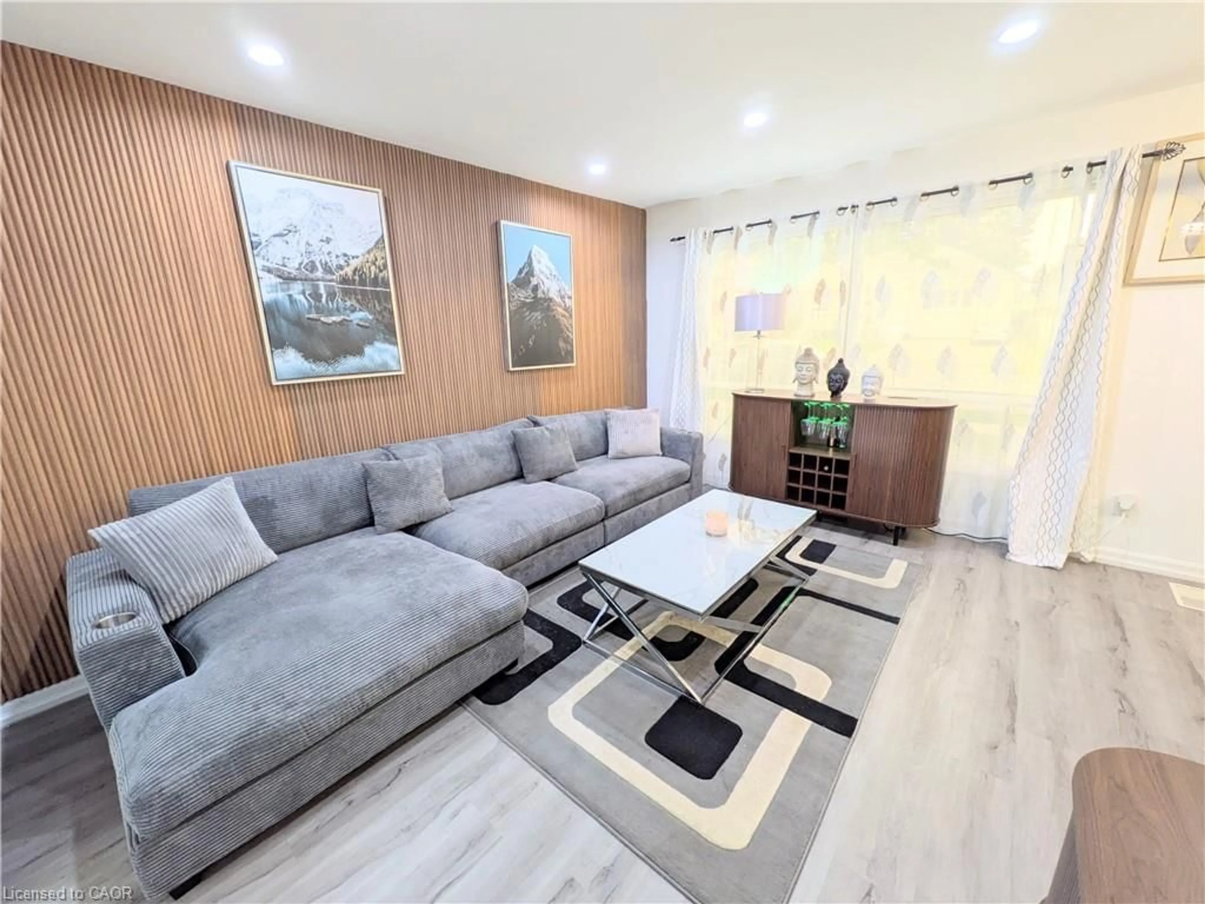 Living room with furniture, wood/laminate floor for 22 Riverdale Dr #1, Hamilton Ontario L8E 1J8