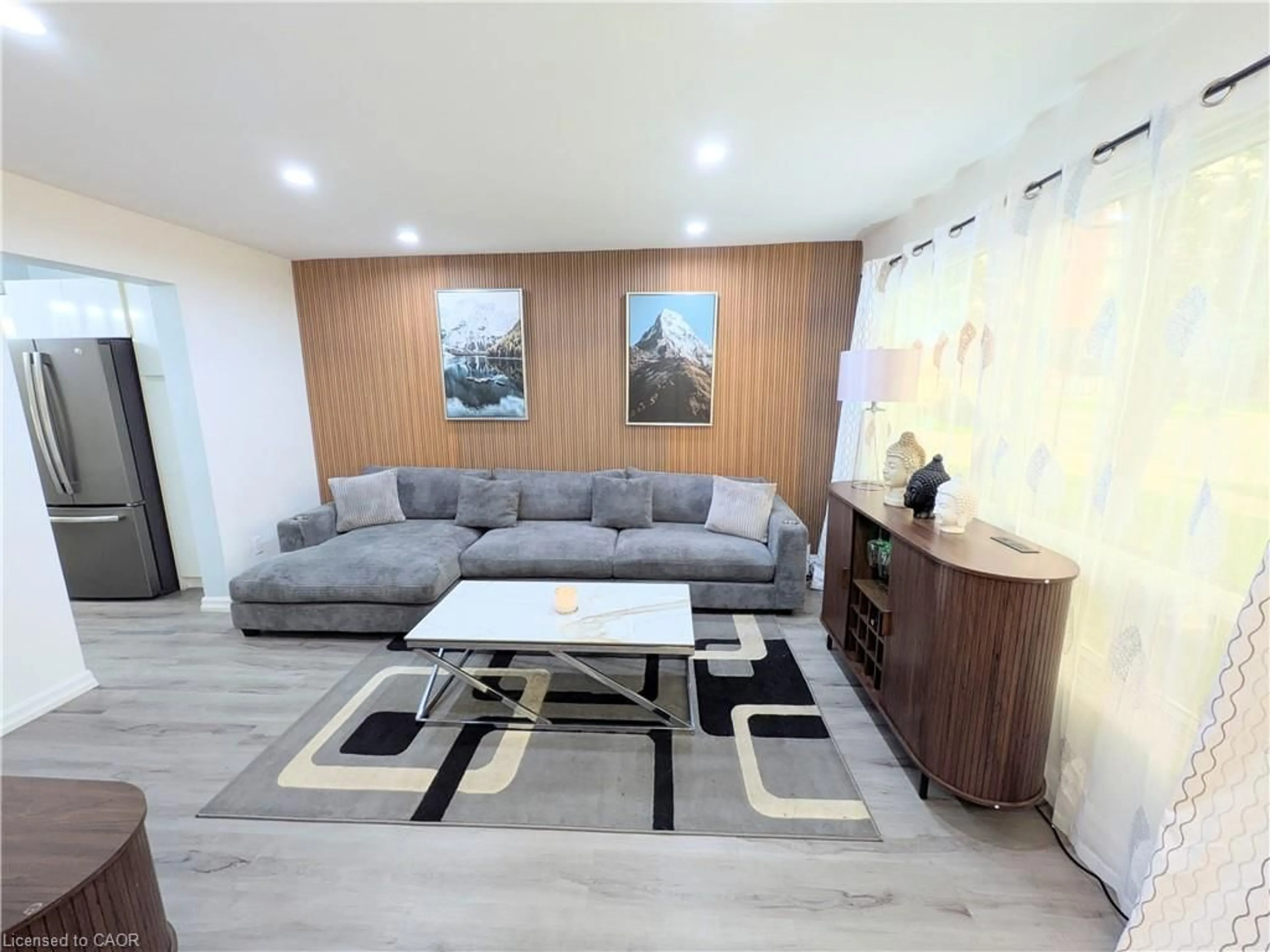 Living room with furniture, wood/laminate floor for 22 Riverdale Dr #1, Hamilton Ontario L8E 1J8