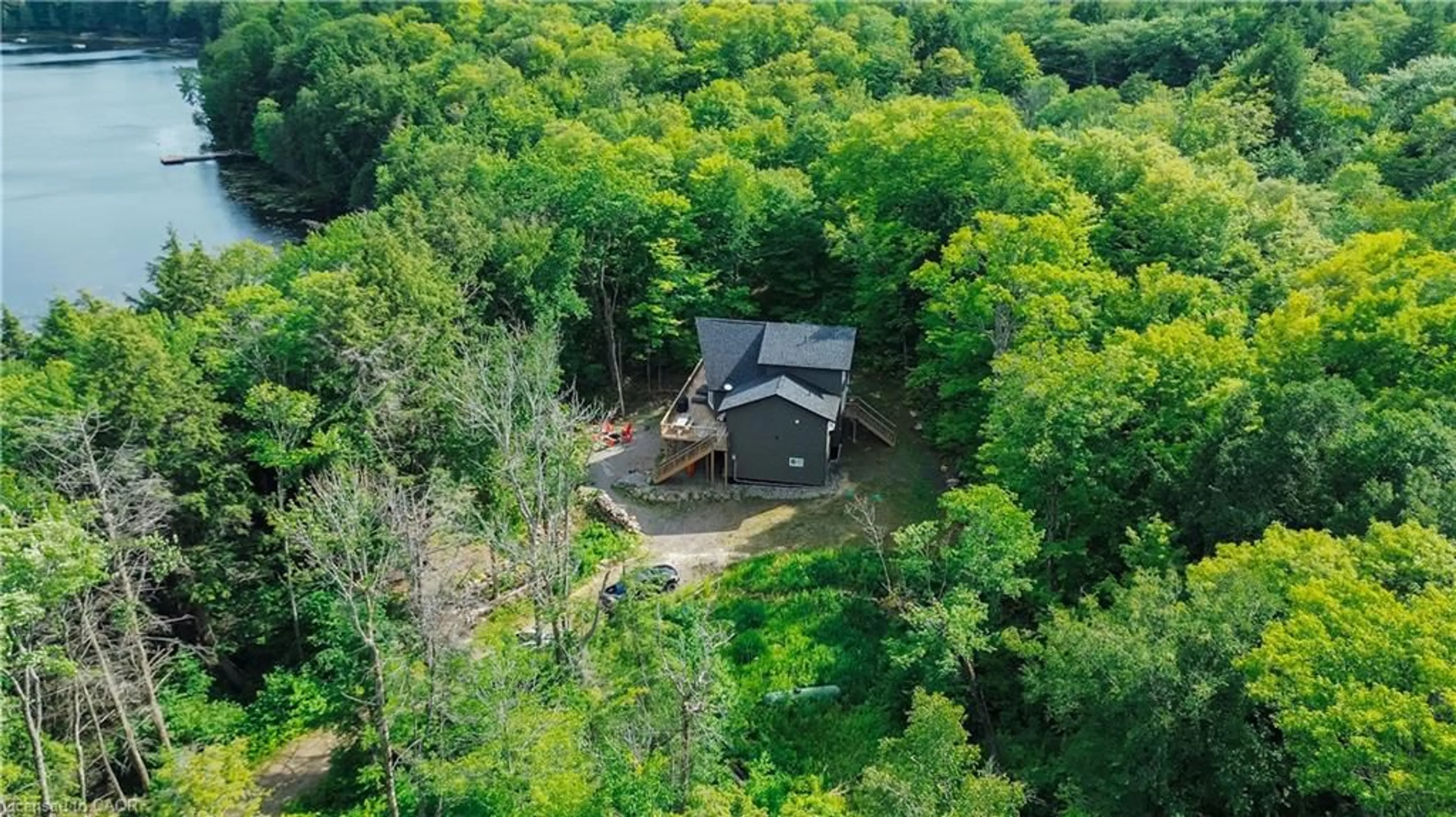 A pic from outside/outdoor area/front of a property/back of a property/a pic from drone, forest/trees view for 95 Chipmunk Lane, Magnetawan Ontario P0A 1P0