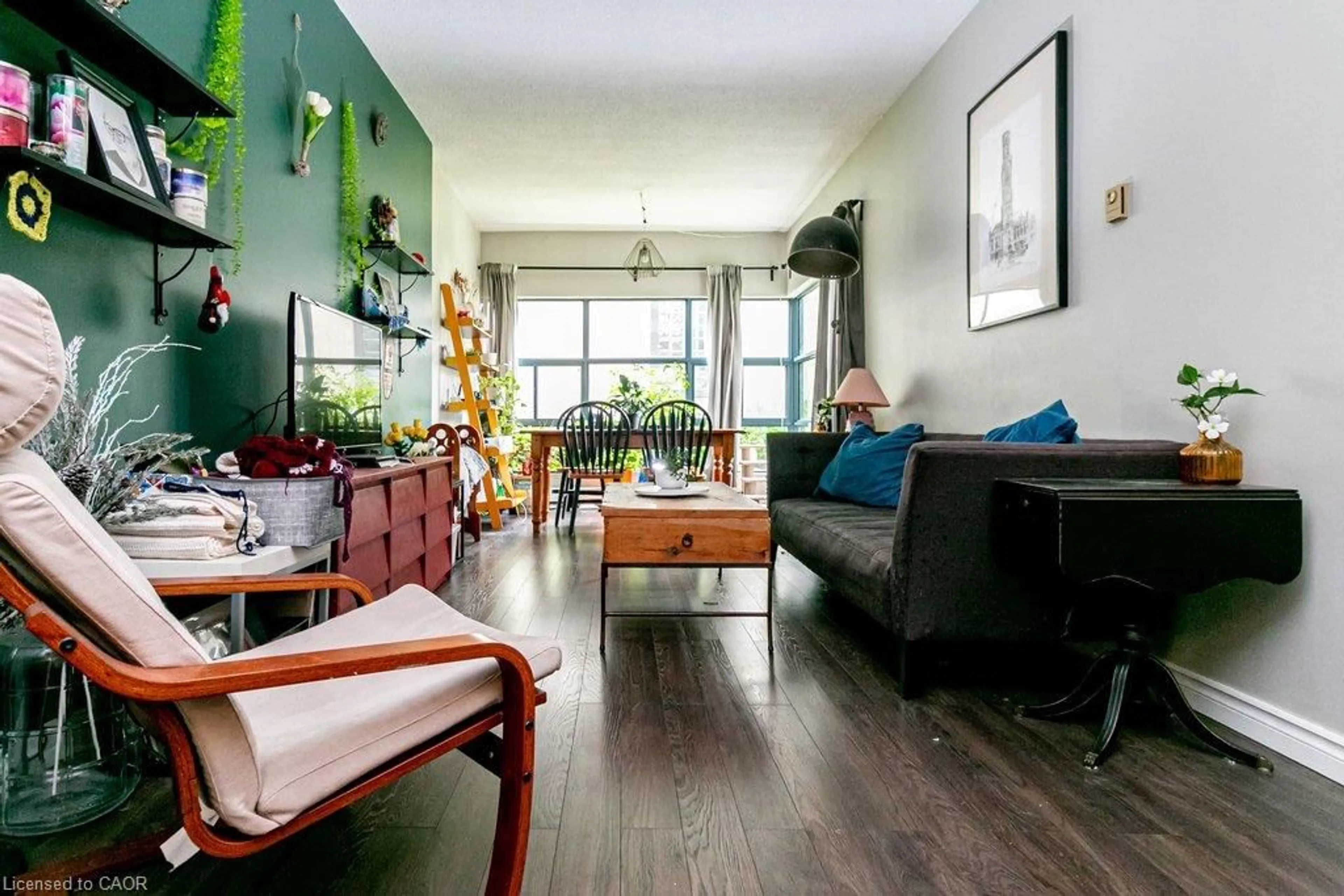 Living room with furniture, wood/laminate floor for 175 Hunter St #103, Hamilton Ontario L8N 4E7