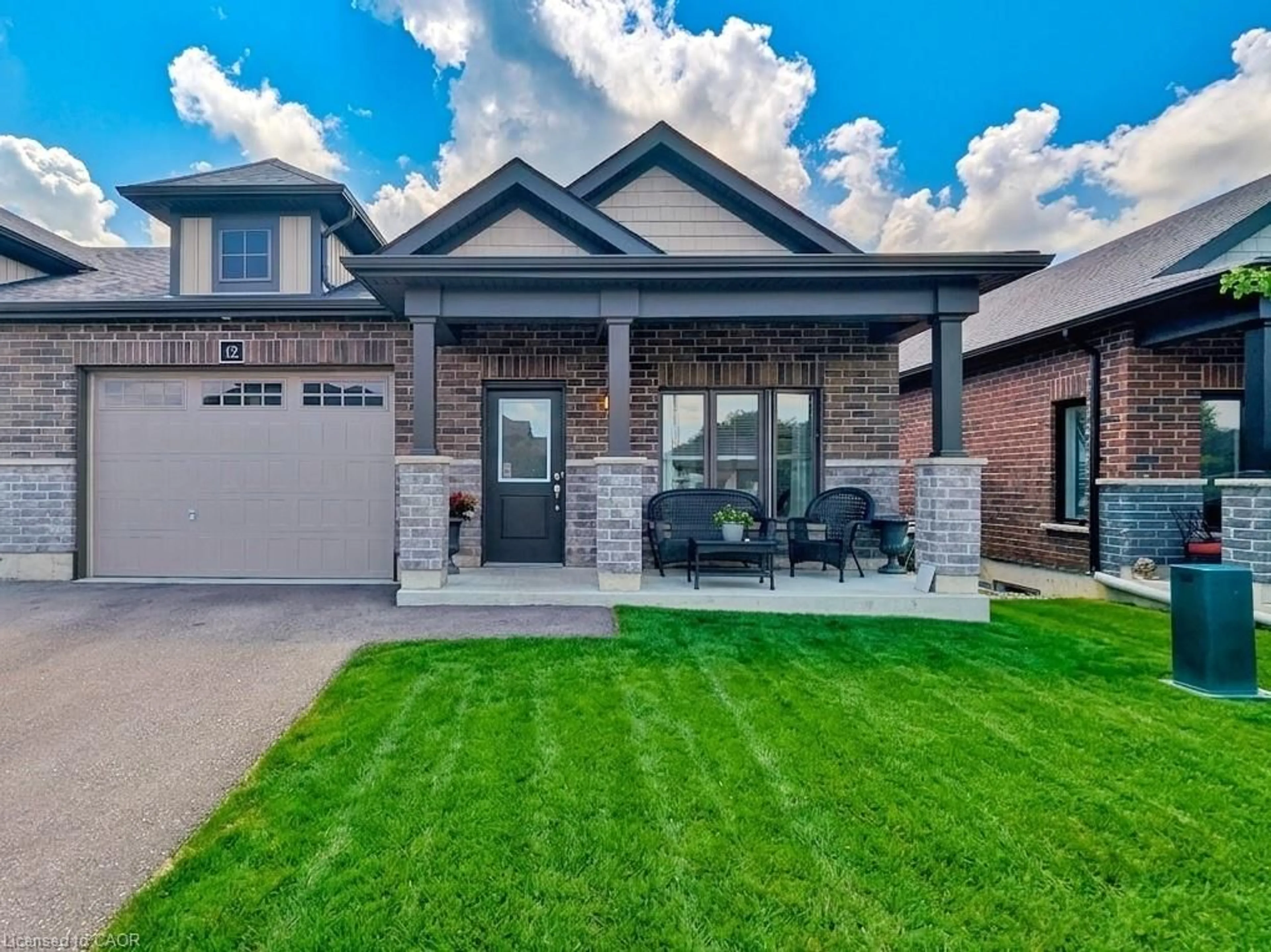 Home with brick exterior material, street for 12 Waterthrush Lane, Simcoe Ontario N3Y 0E9