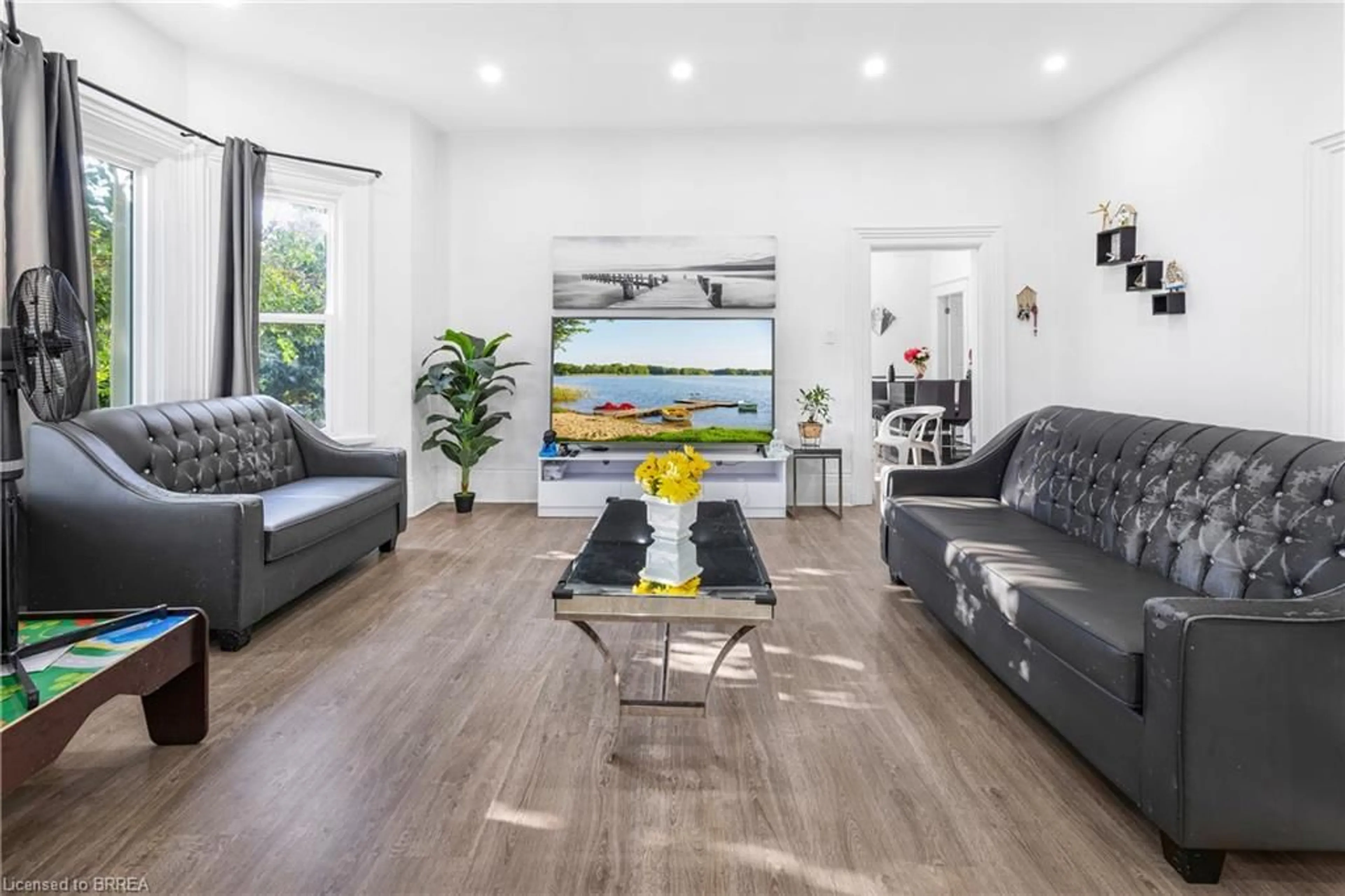 Living room with furniture, wood/laminate floor for 472 Colborne St, Brantford Ontario N3S 3P1