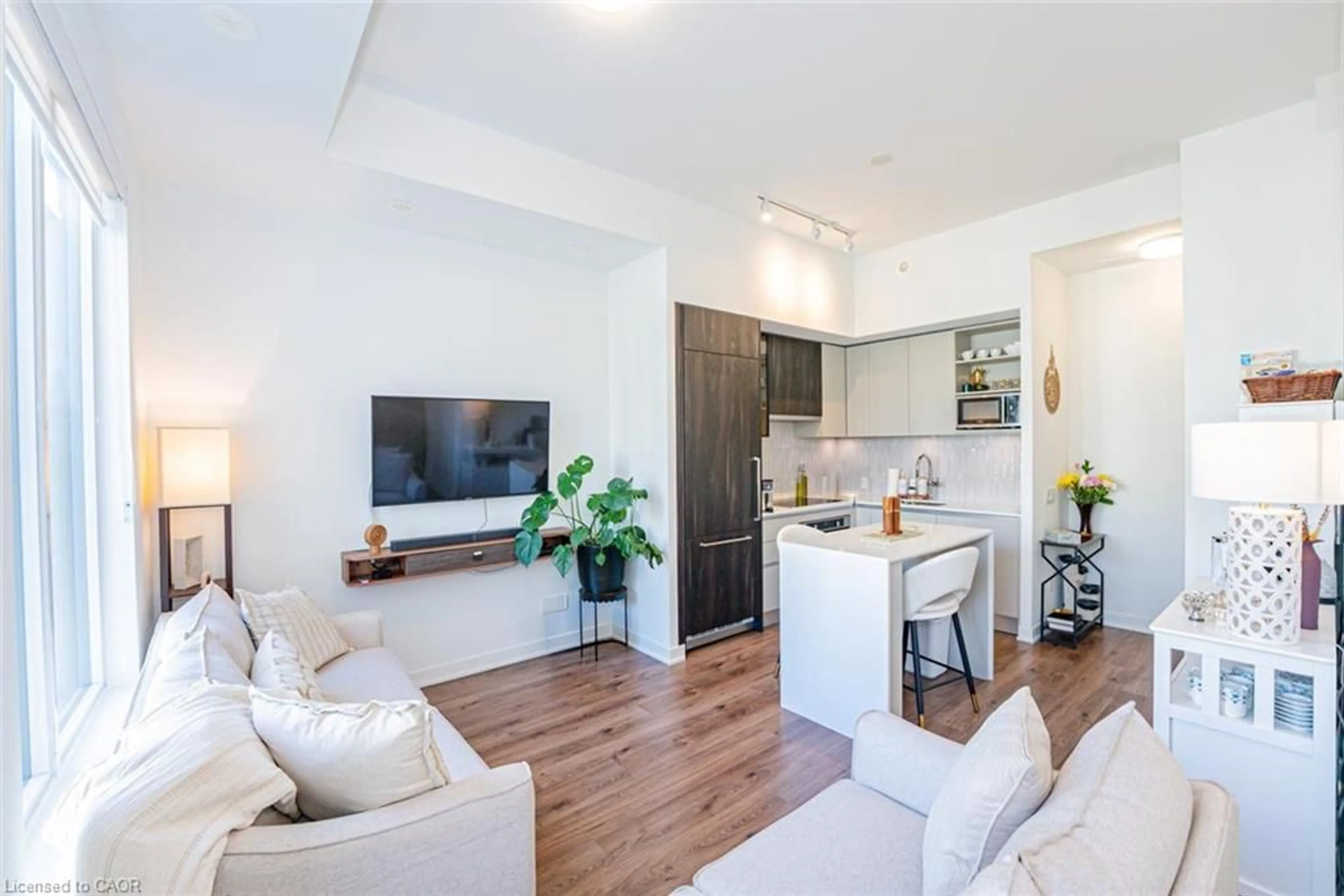 Living room with furniture, wood/laminate floor for 3020 Trailside Dr #129, Oakville Ontario L6M 5R1