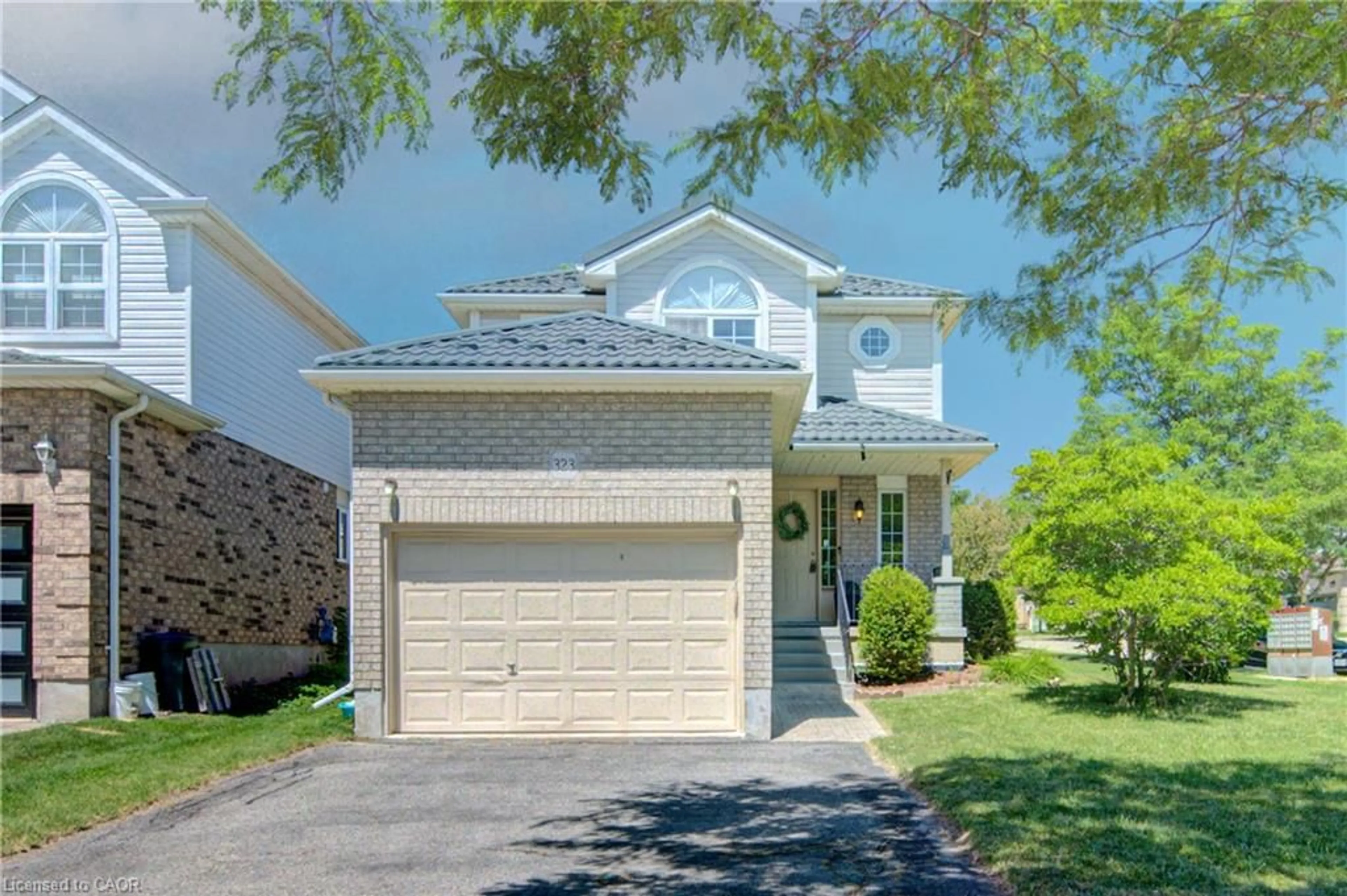 Home with vinyl exterior material, street for 323 Hidden Creek Dr, Kitchener Ontario N2N 3N3