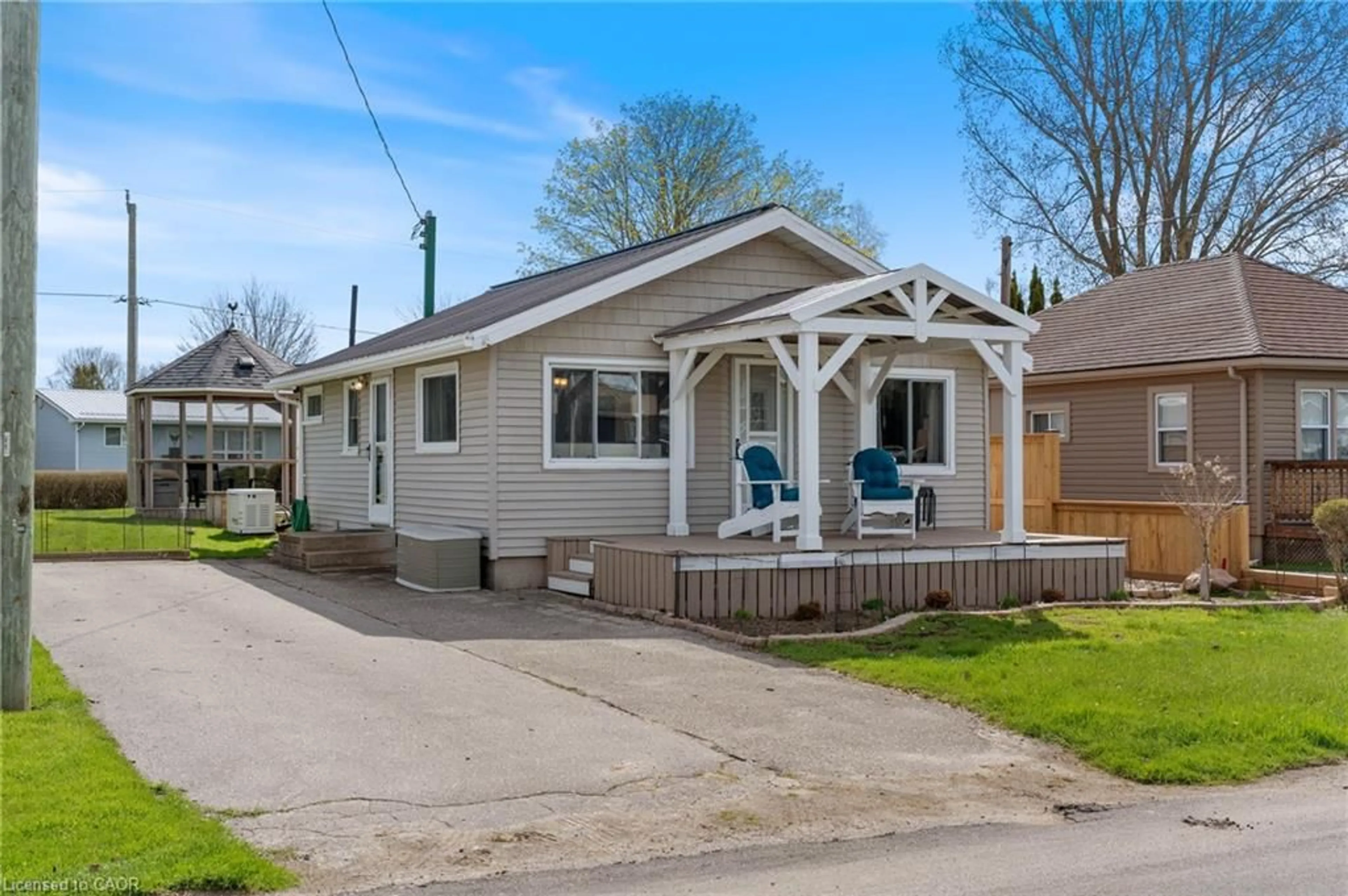 Home with vinyl exterior material, street for 21 Fourth Ave, Long Point Ontario N0E 1M0