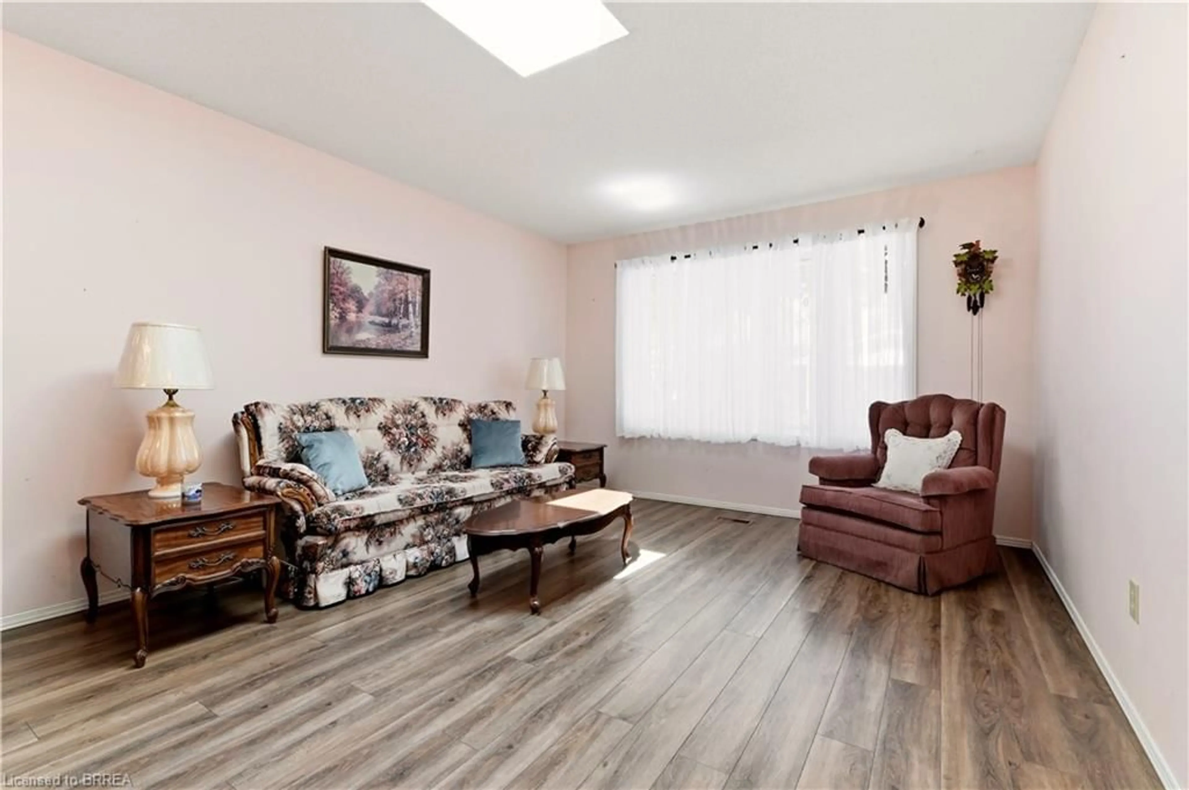Living room with furniture, wood/laminate floor for 1030 Colborne St #19, Brantford Ontario N3S 3T6
