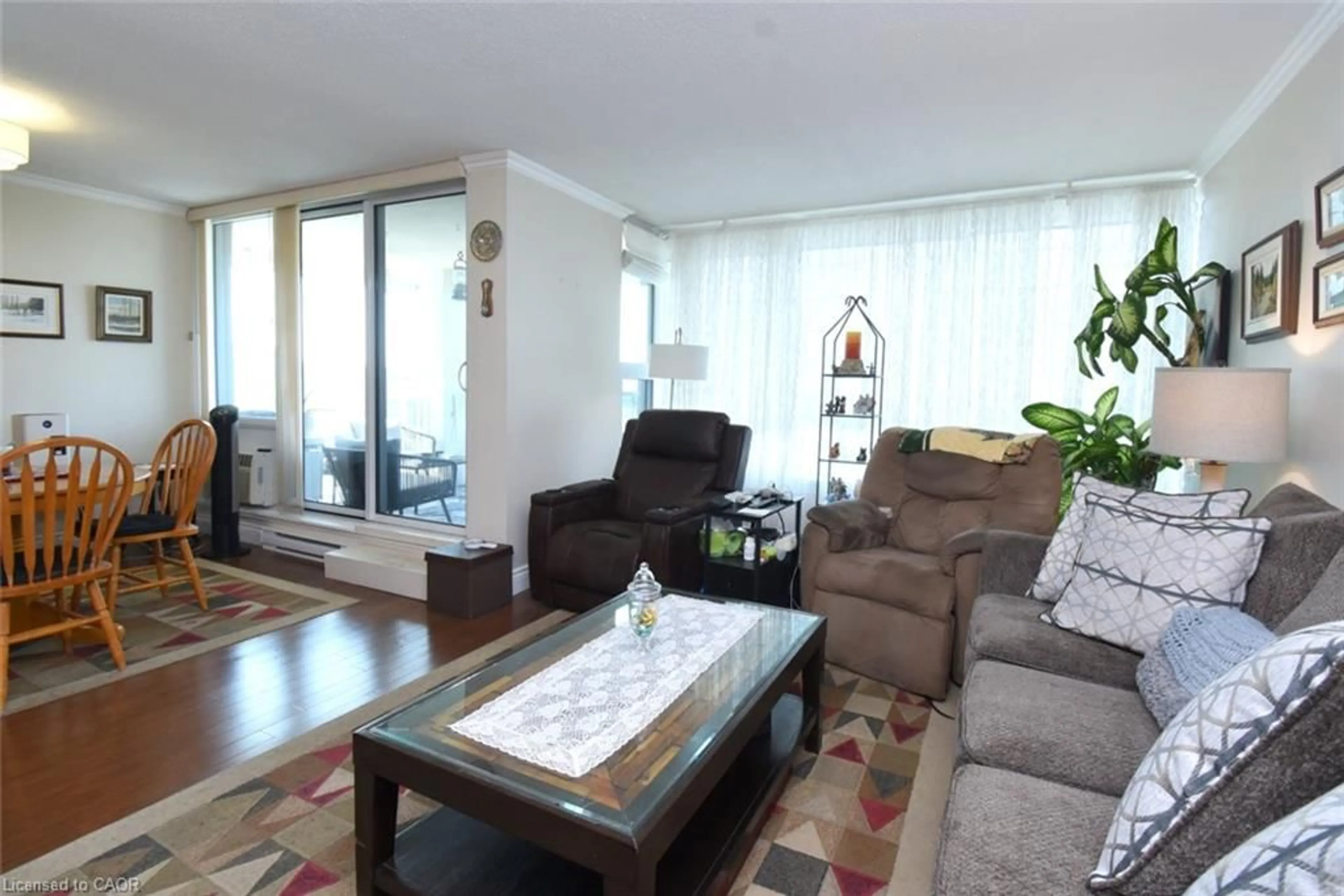 Living room with furniture, wood/laminate floor for 75 Queen St #1204, Hamilton Ontario L8R 3J3