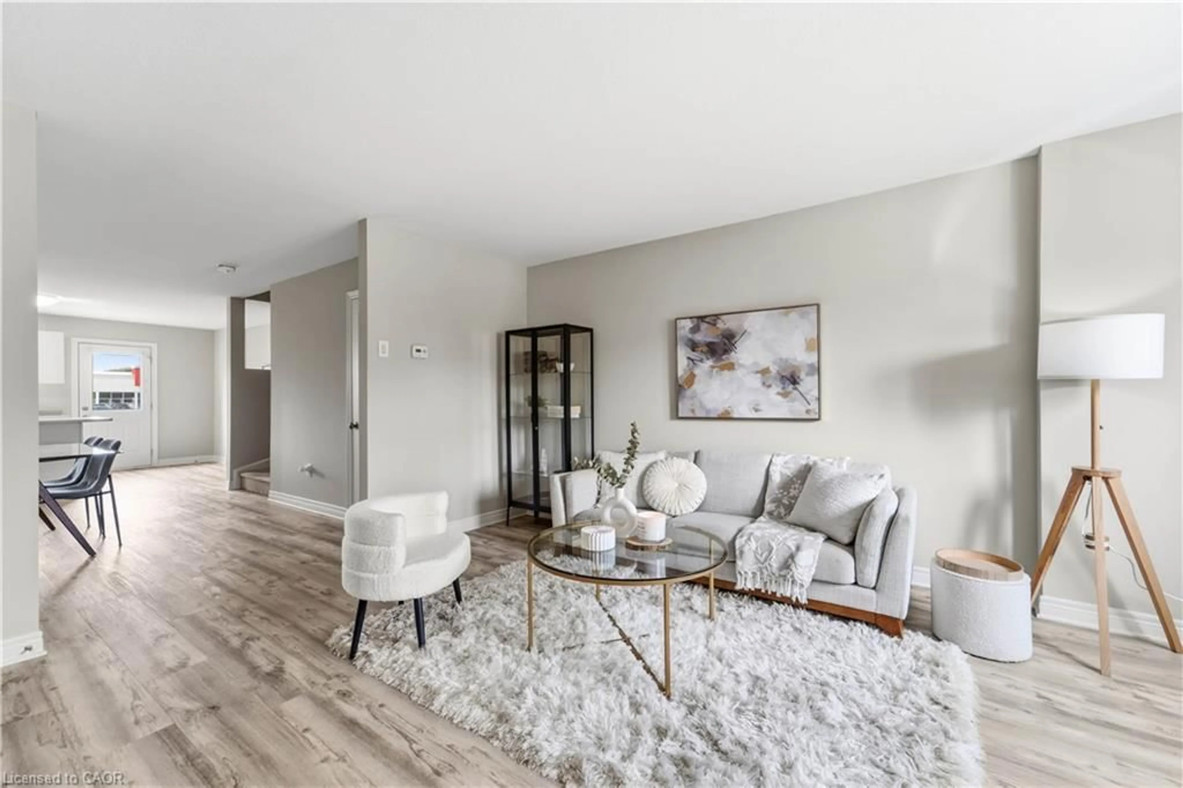 Living room with furniture, wood/laminate floor for 7768 Ascot Cir #5, Niagara Falls Ontario L2H 3P9