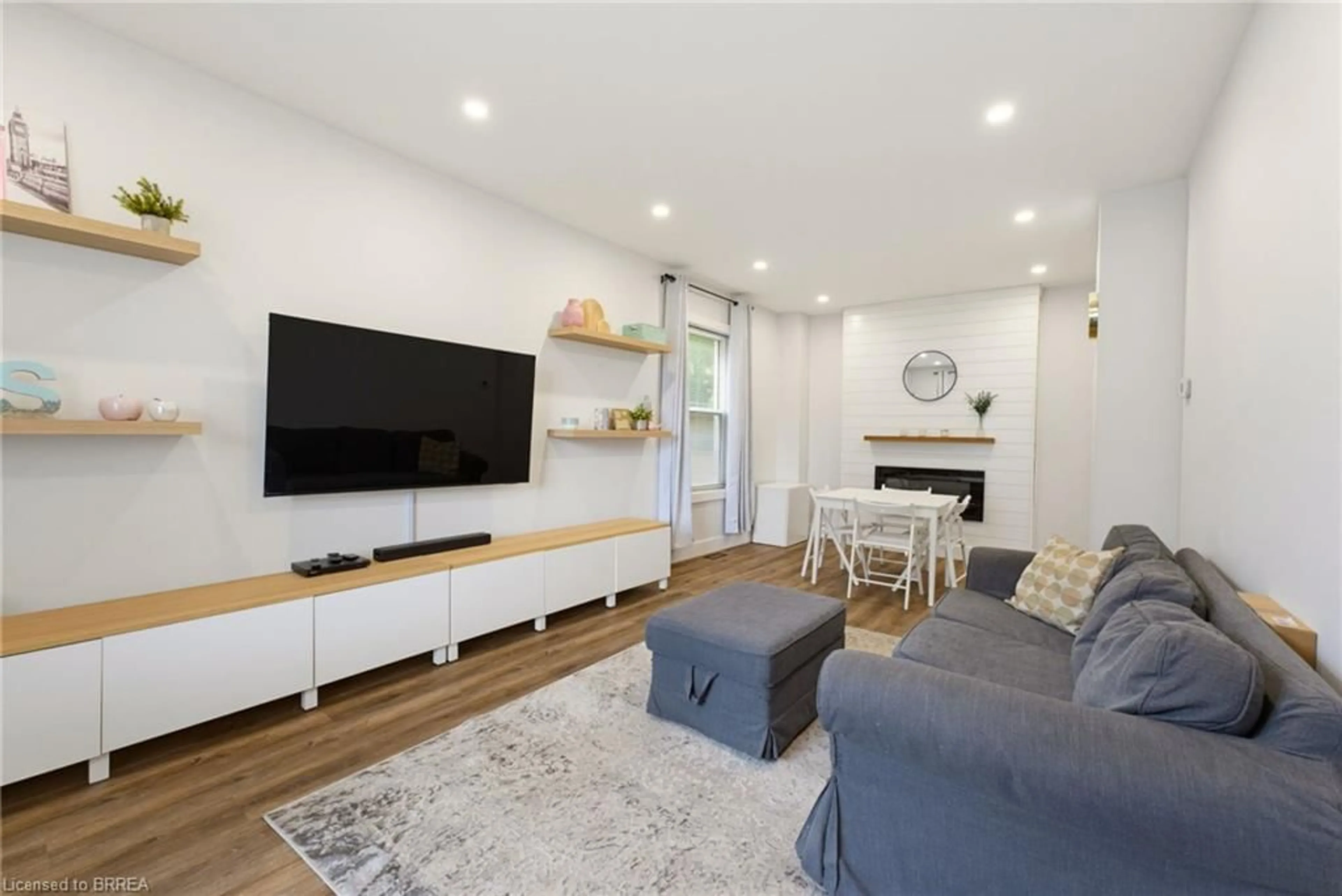 Living room with furniture, wood/laminate floor for 277 Murray St, Brantford Ontario N3S 5S7