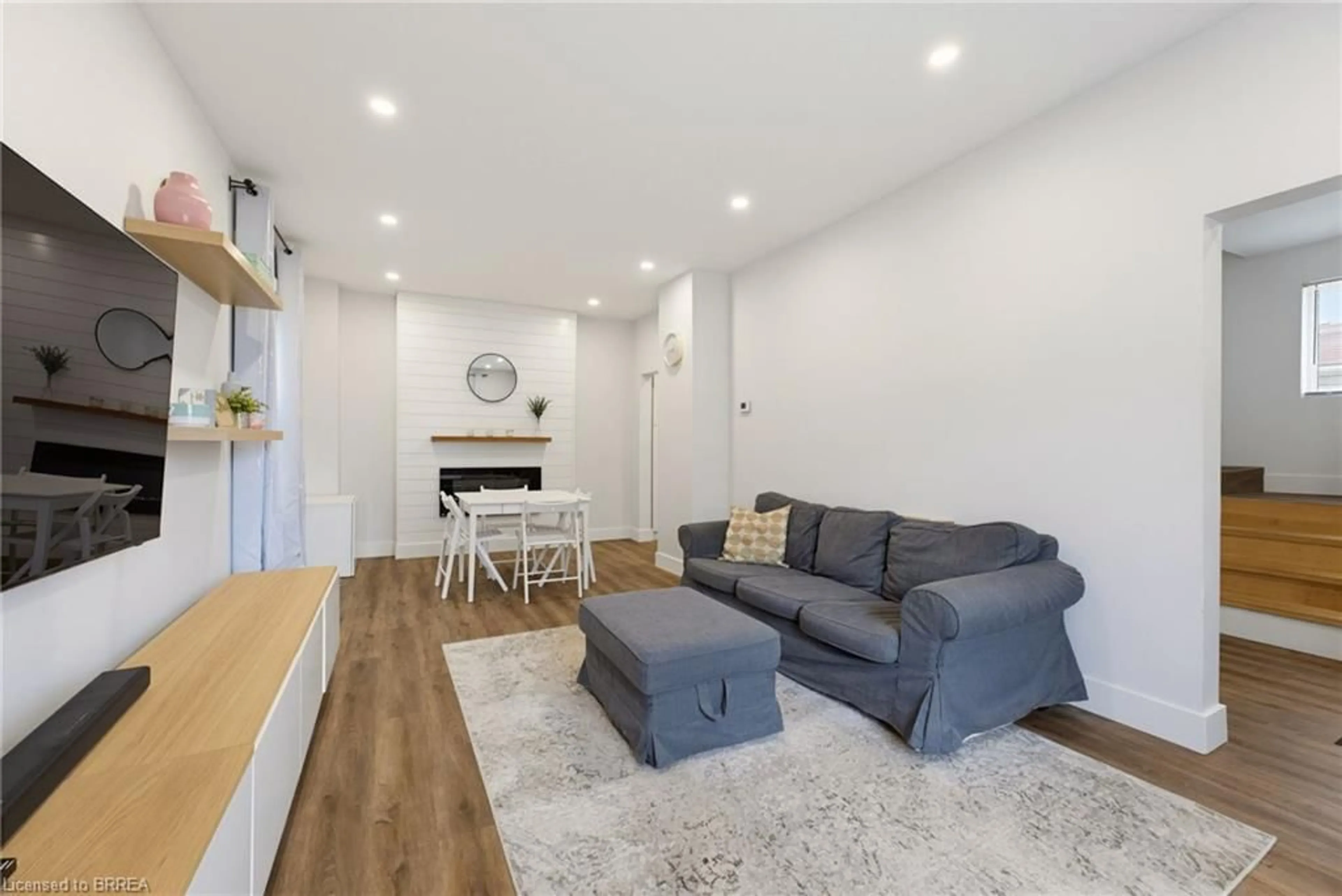 Living room with furniture, wood/laminate floor for 277 Murray St, Brantford Ontario N3S 5S7