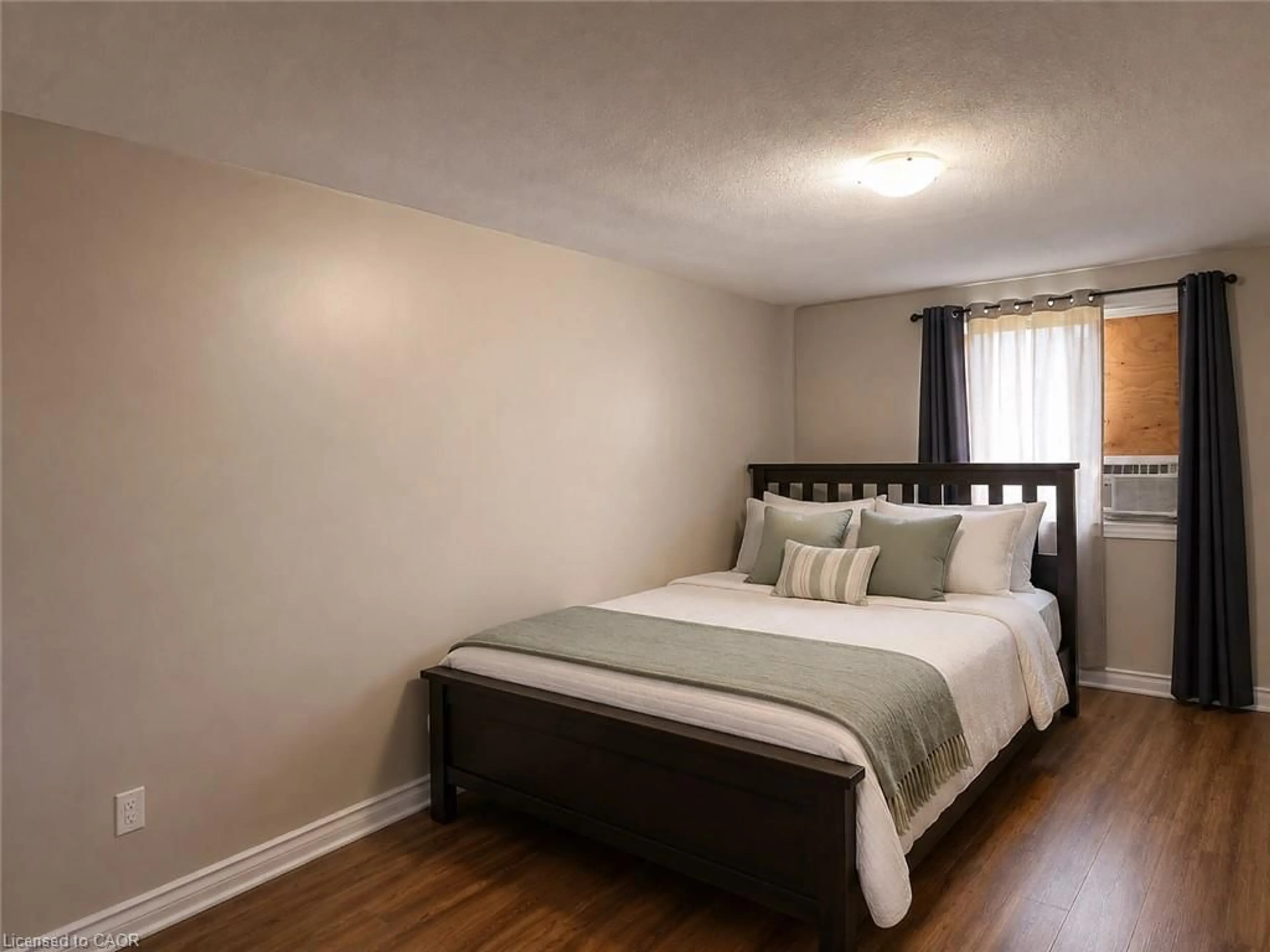 Bedroom with bed, wood/laminate floor for 633 Barber Ave #7, Listowel Ontario N4W 1S4
