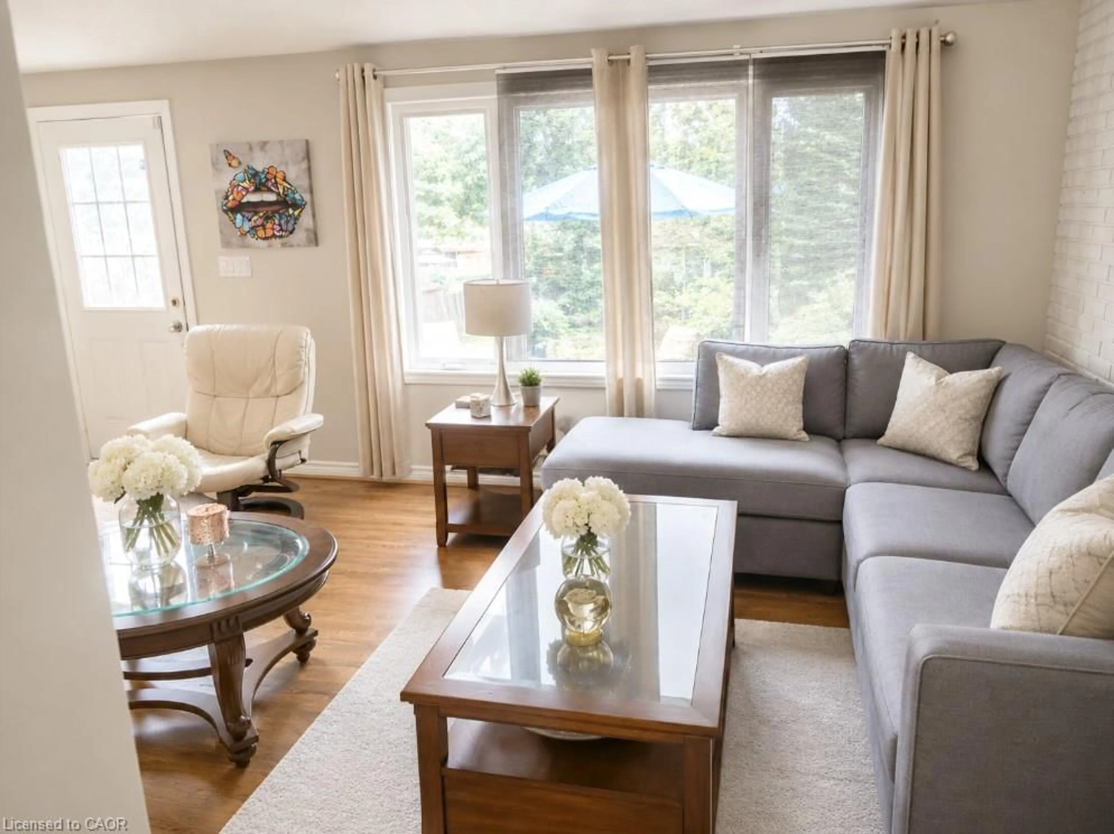 Living room with furniture, wood/laminate floor for 636 Elgin St, Cambridge Ontario N1R 5Z5