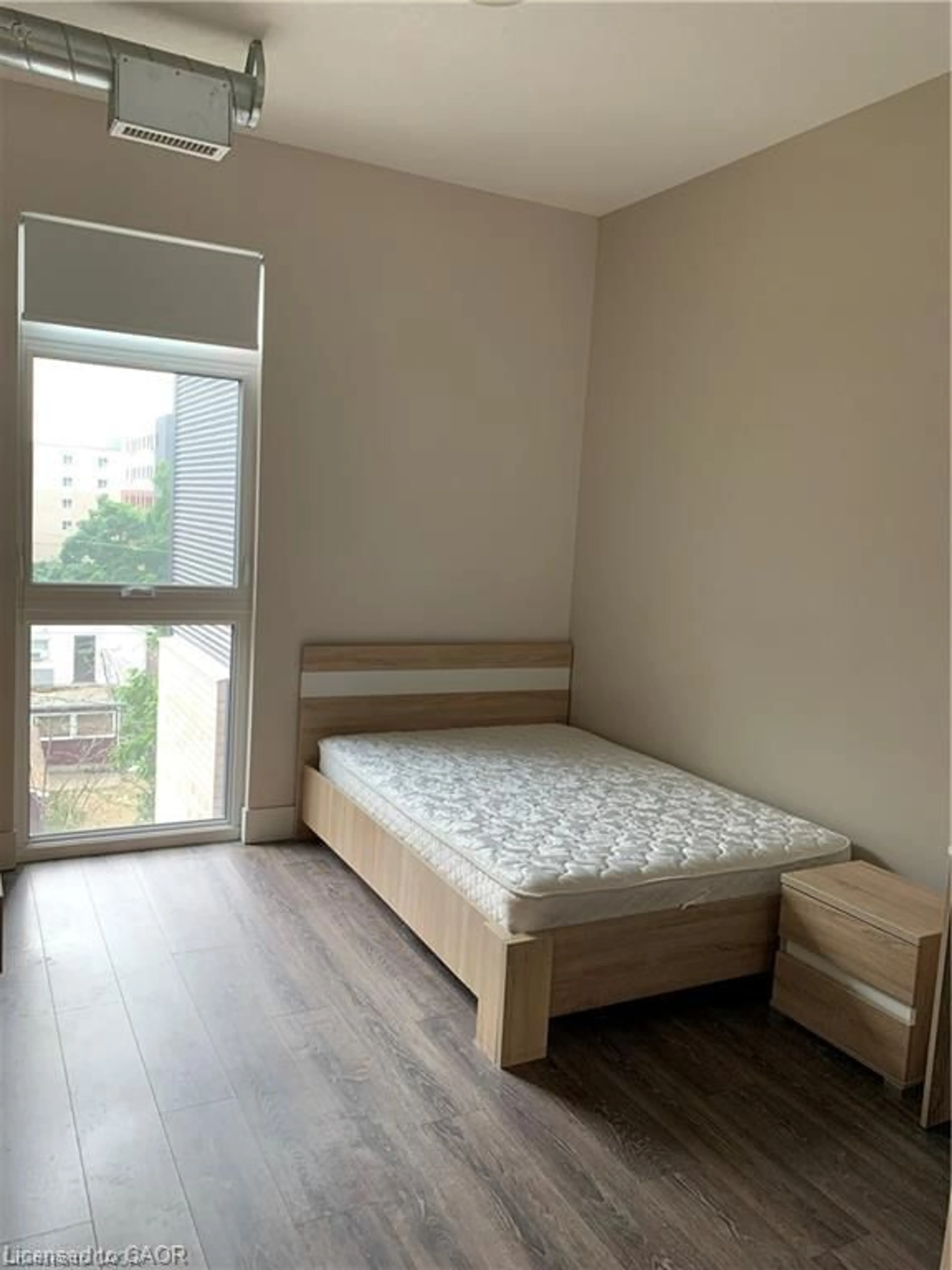 Bedroom with bed, wood/laminate floor for 253 Albert St #408, Waterloo Ontario N2L 0G3