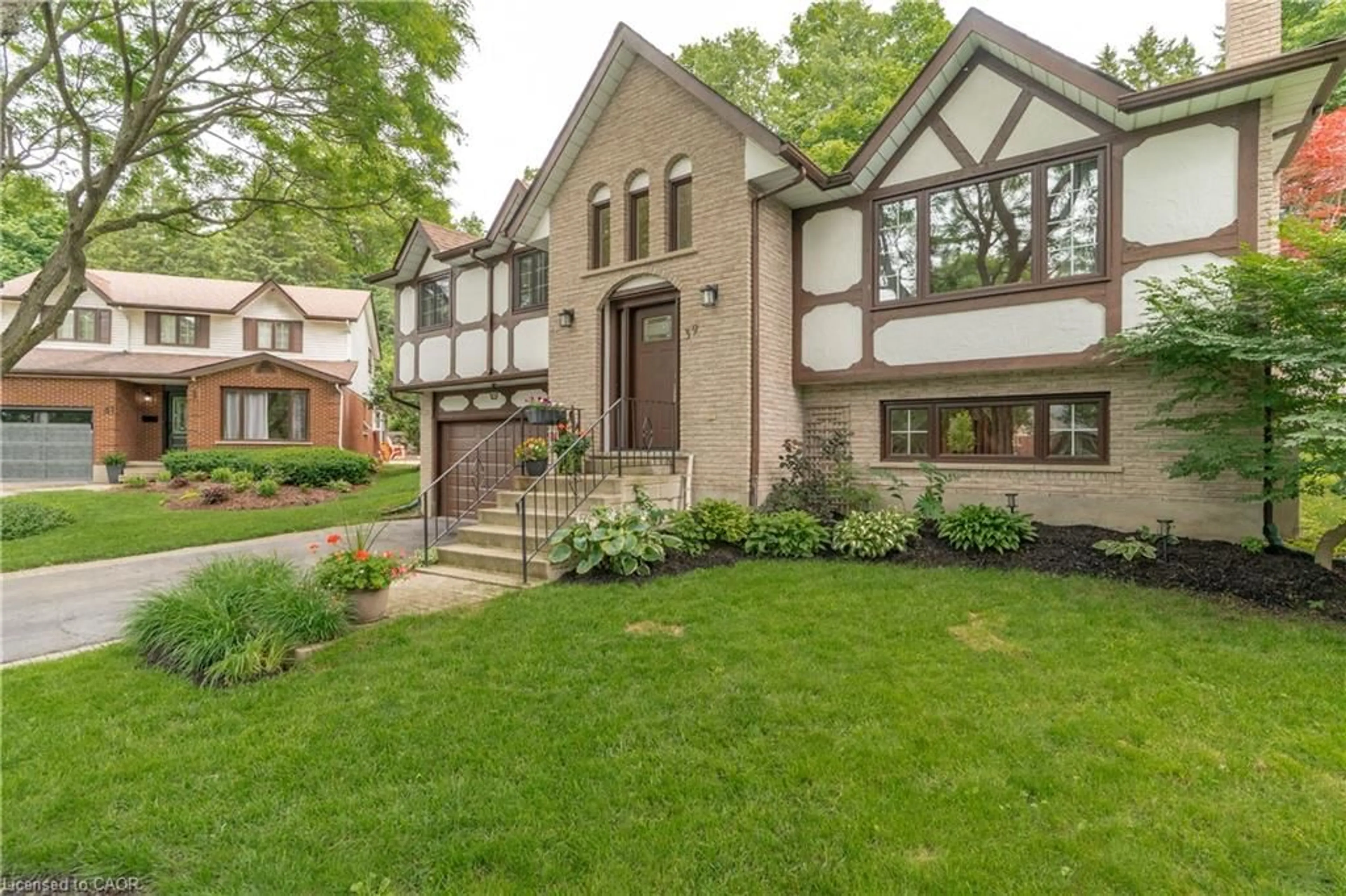 Home with brick exterior material, street for 39 Wagoners Trail, Guelph Ontario N1G 3M9