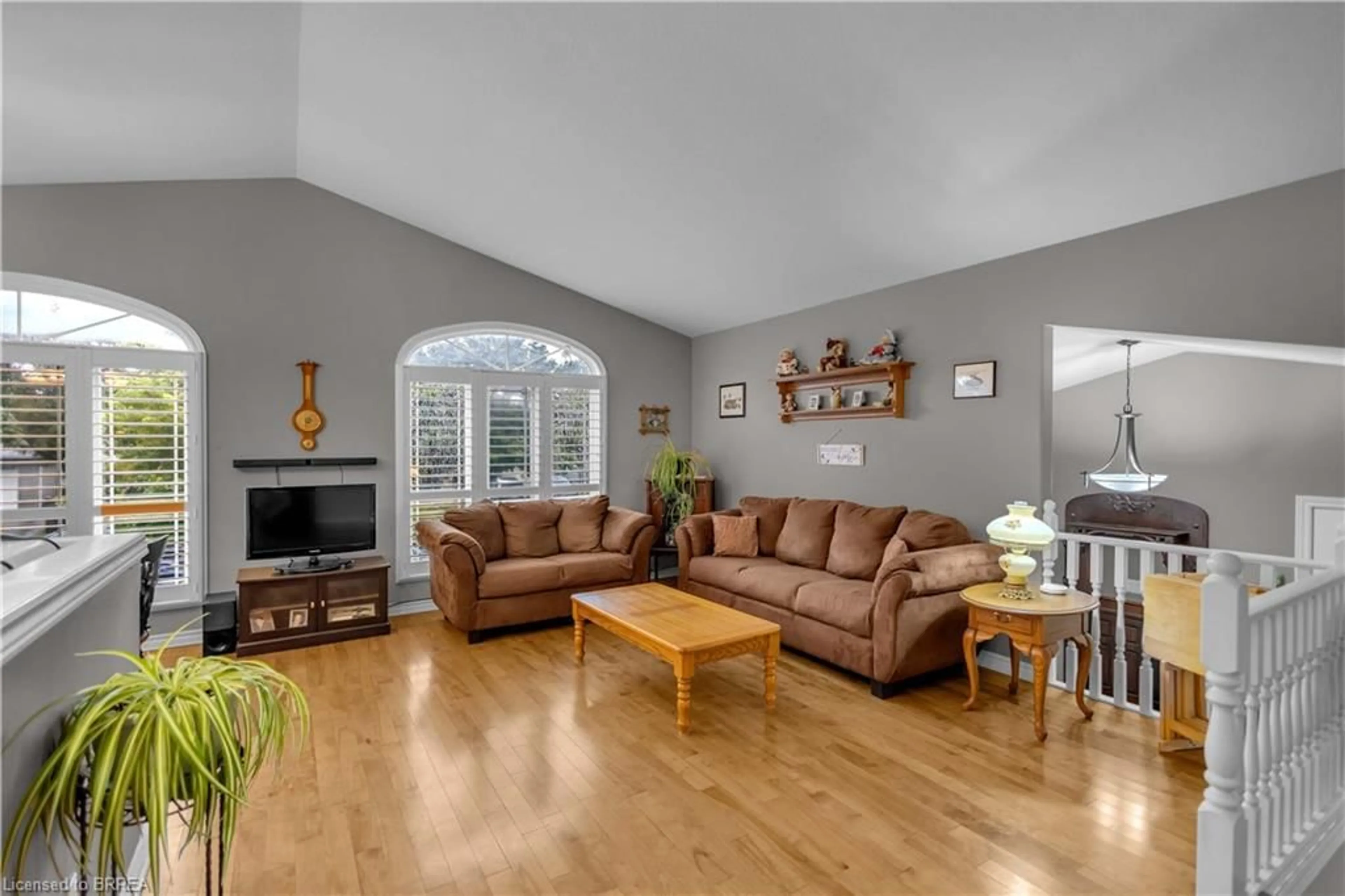 Living room with furniture, wood/laminate floor for 5 Passmore Crt, Brantford Ontario N3S 7V3