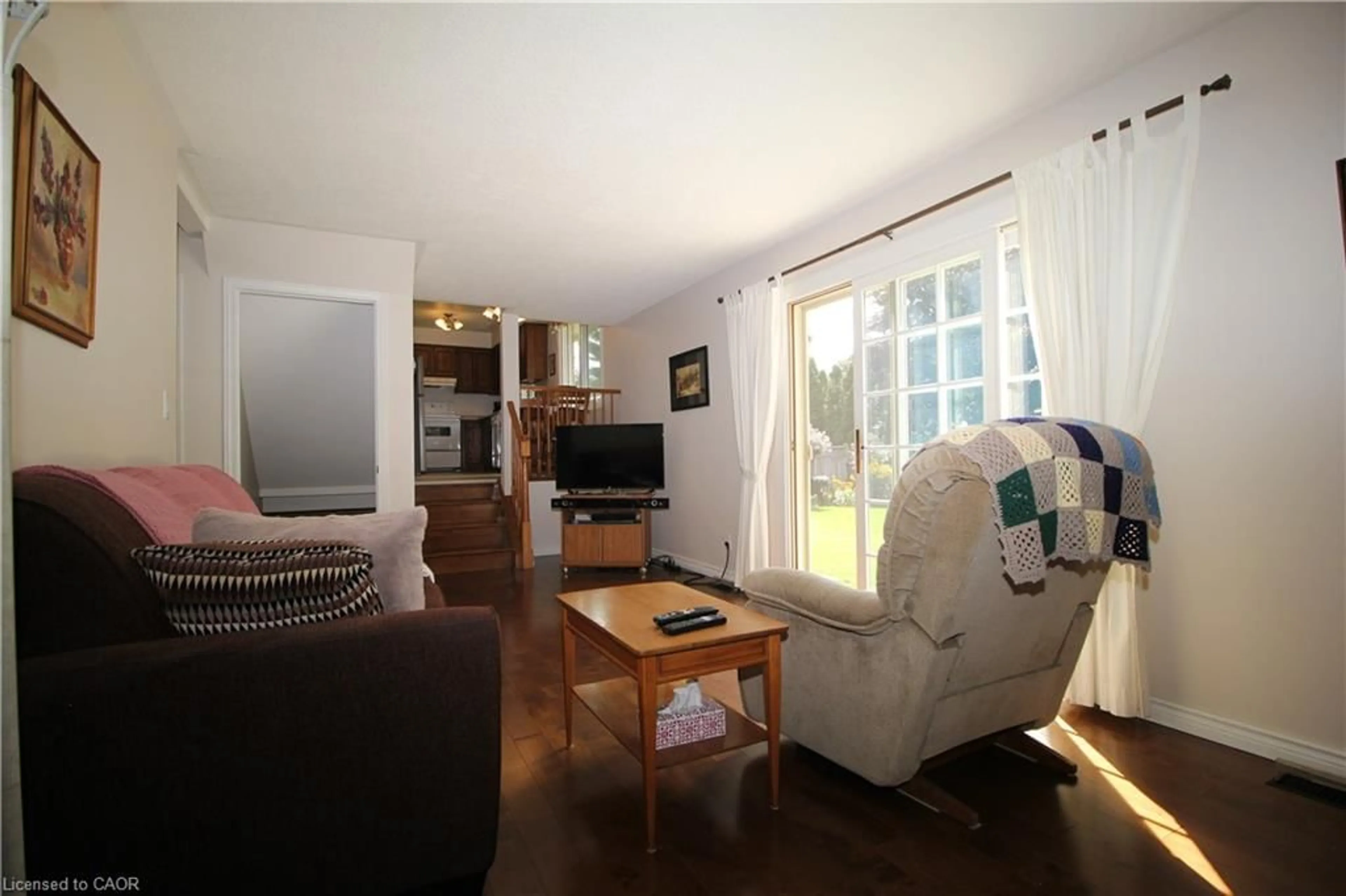 Living room with furniture, wood/laminate floor for 14 Berkley Cres, Simcoe Ontario N3Y 4T4