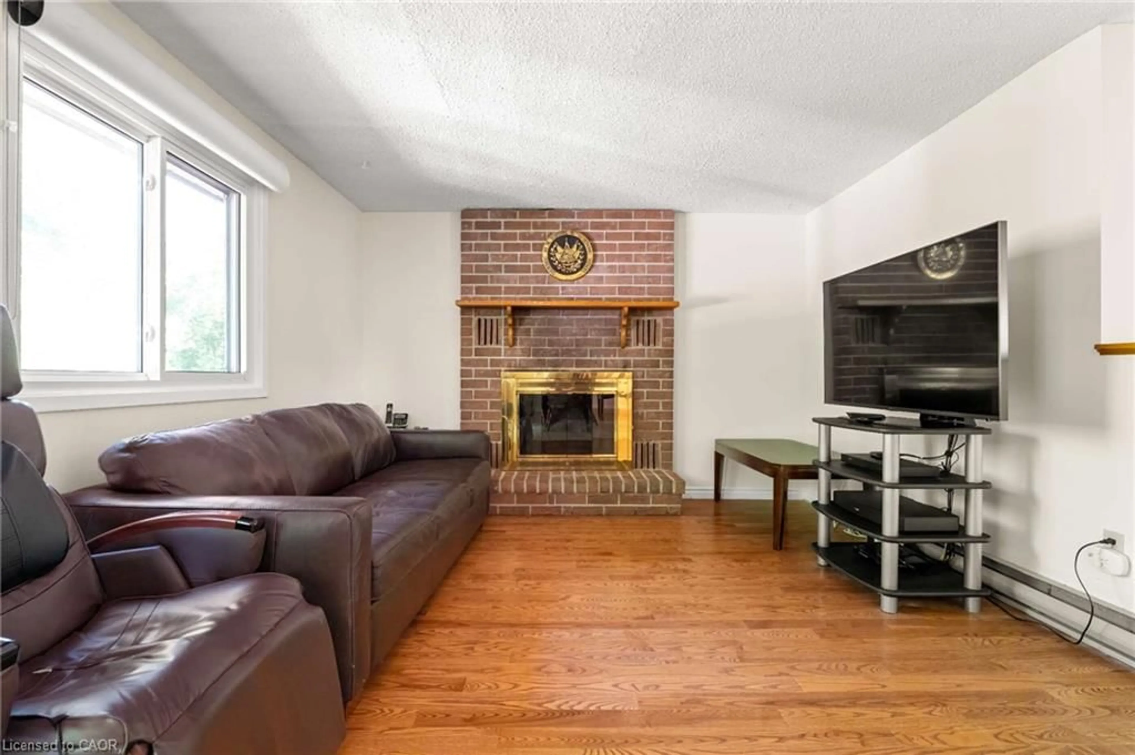 Living room with furniture, wood/laminate floor for 121 Imperial Rd, Guelph Ontario N1H 7Z5