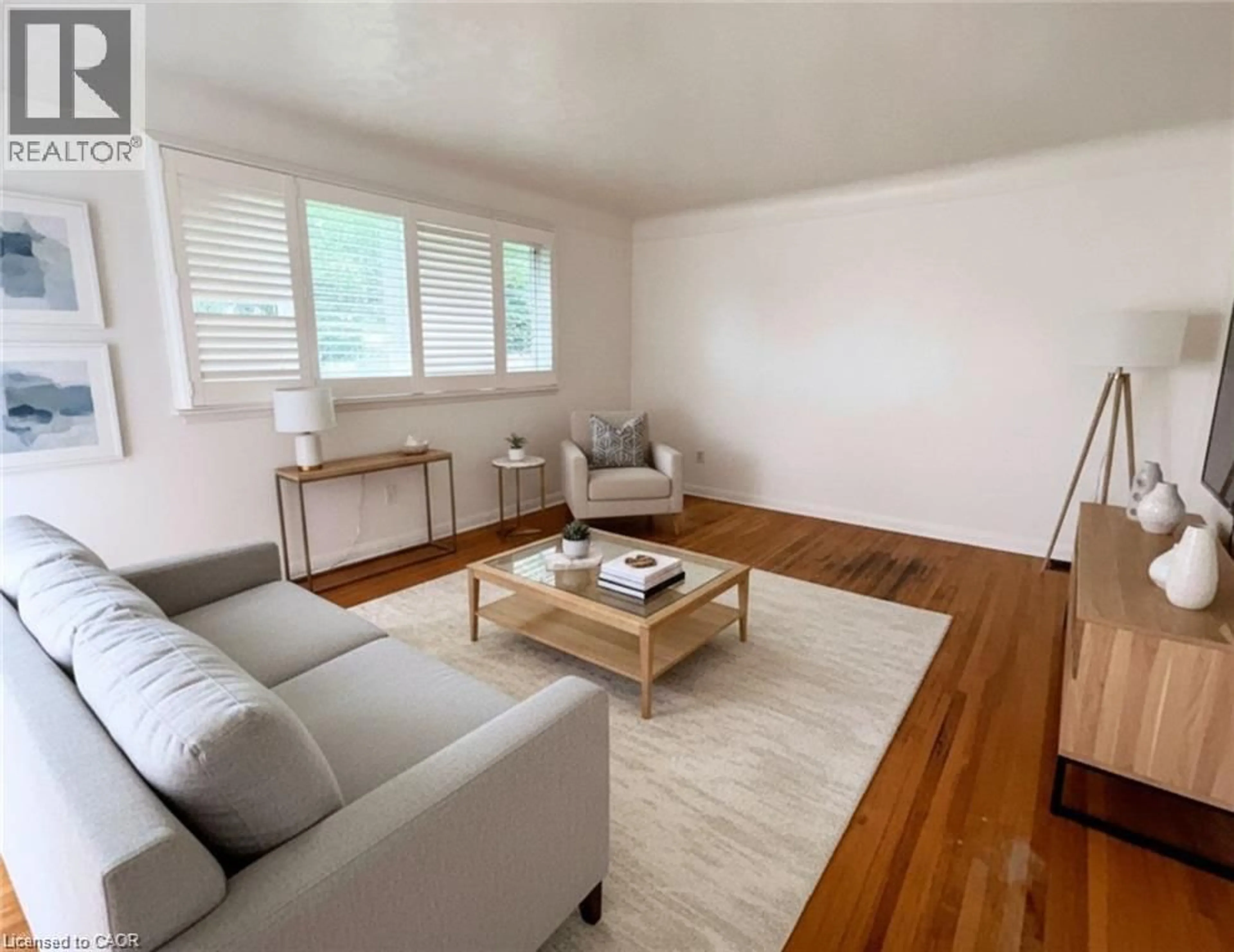 Living room with furniture, wood/laminate floor for 83 East 41st St, Hamilton Ontario L8T 2Z5