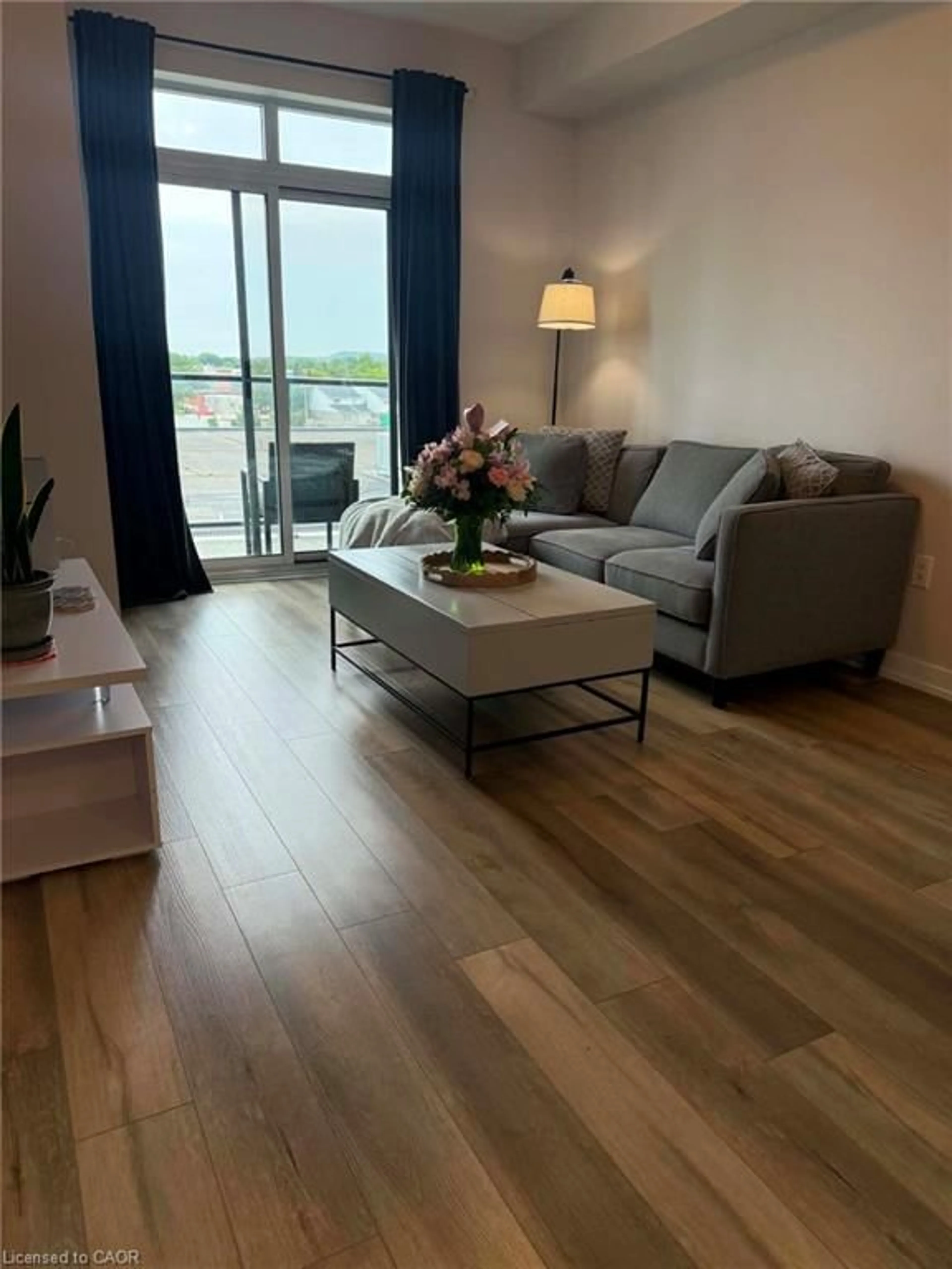 Living room with furniture, wood/laminate floor for 5055 Greenlane Rd #415, Beamsville Ontario L3J 2J3