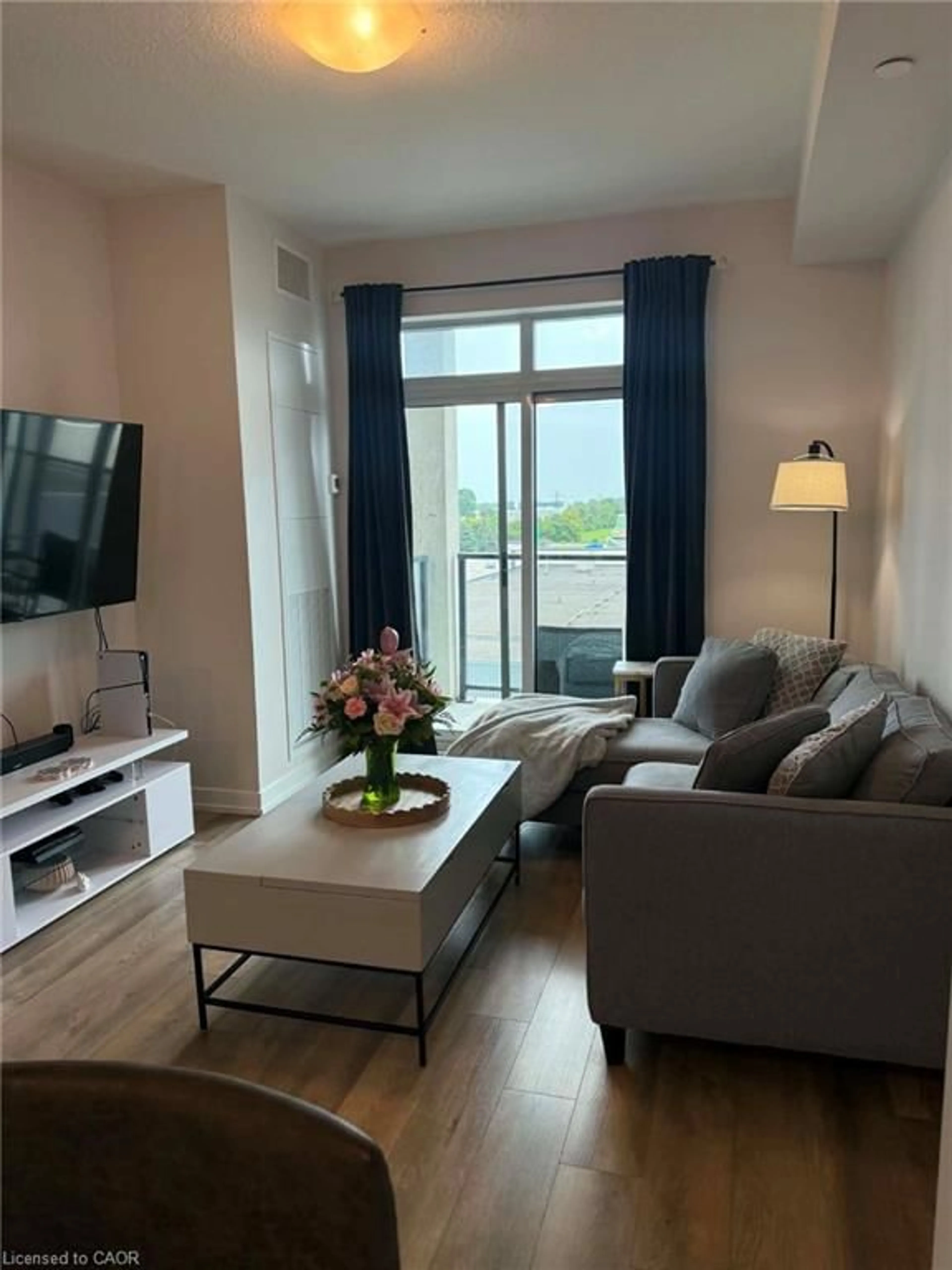 Living room with furniture, wood/laminate floor for 5055 Greenlane Rd #415, Beamsville Ontario L3J 2J3