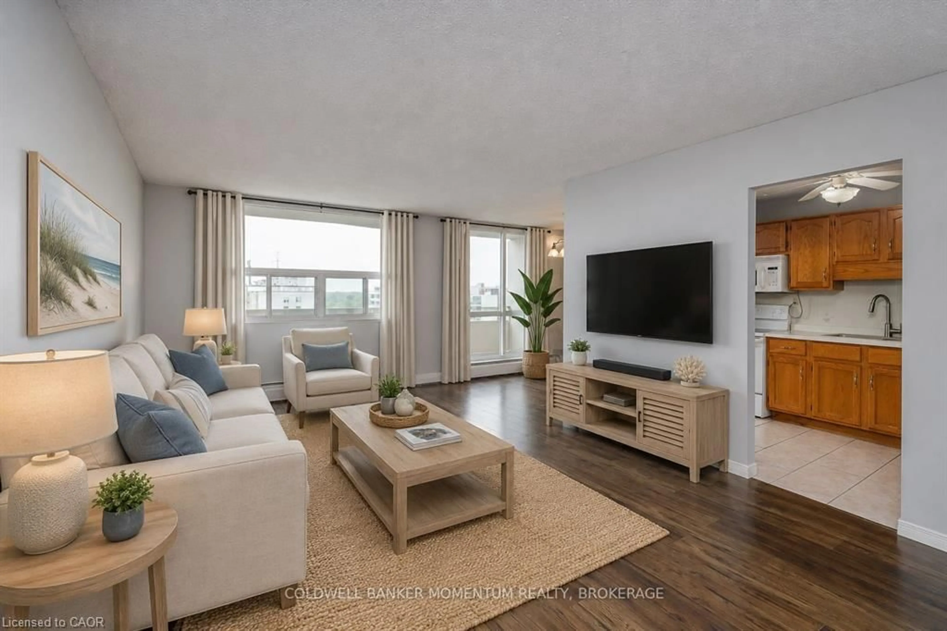 Living room with furniture, wood/laminate floor for 365 Geneva St #1002, St. Catharines Ontario L2N 5S7