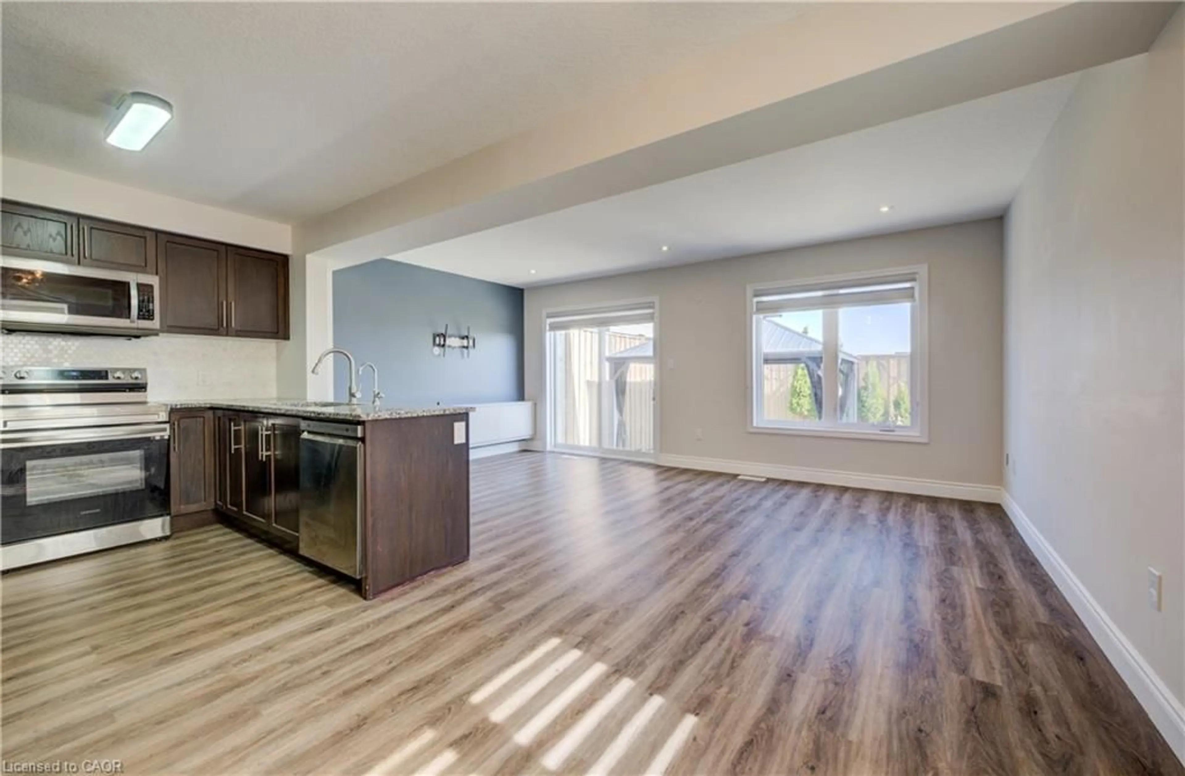 Open concept kitchen, wood/laminate floor for 80 Miranda Path, Elmira Ontario N3B 1N3