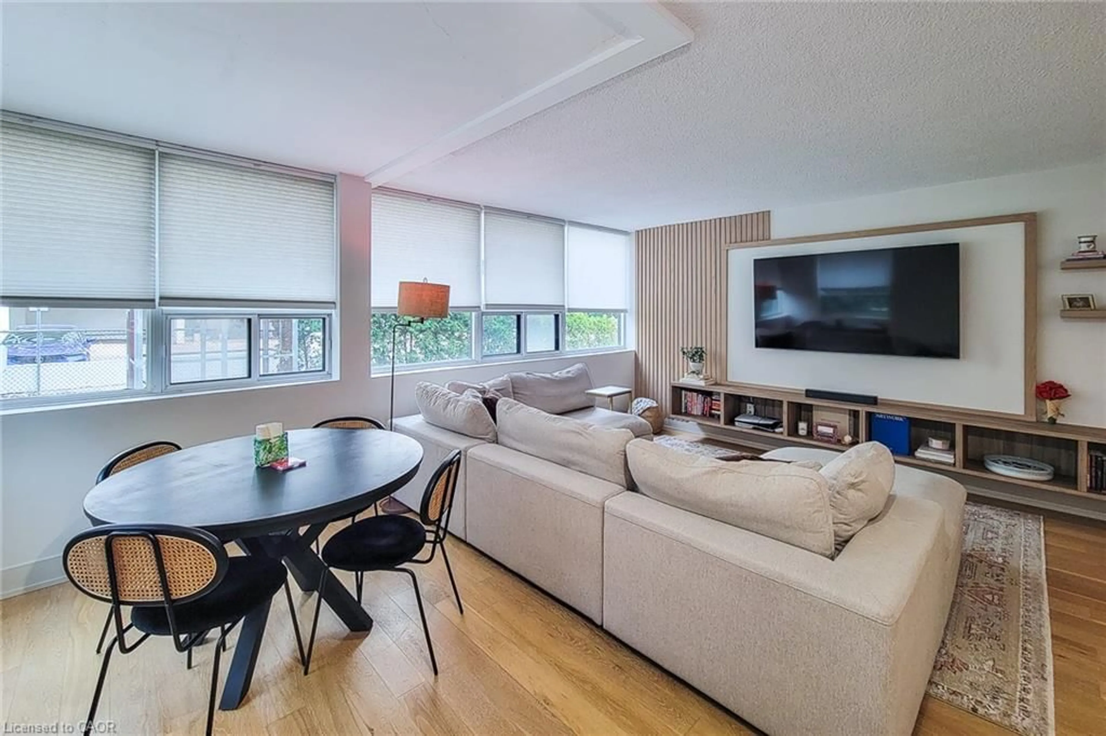Living room with furniture, wood/laminate floor for 120 Duke St #202, Hamilton Ontario L8P 4T1