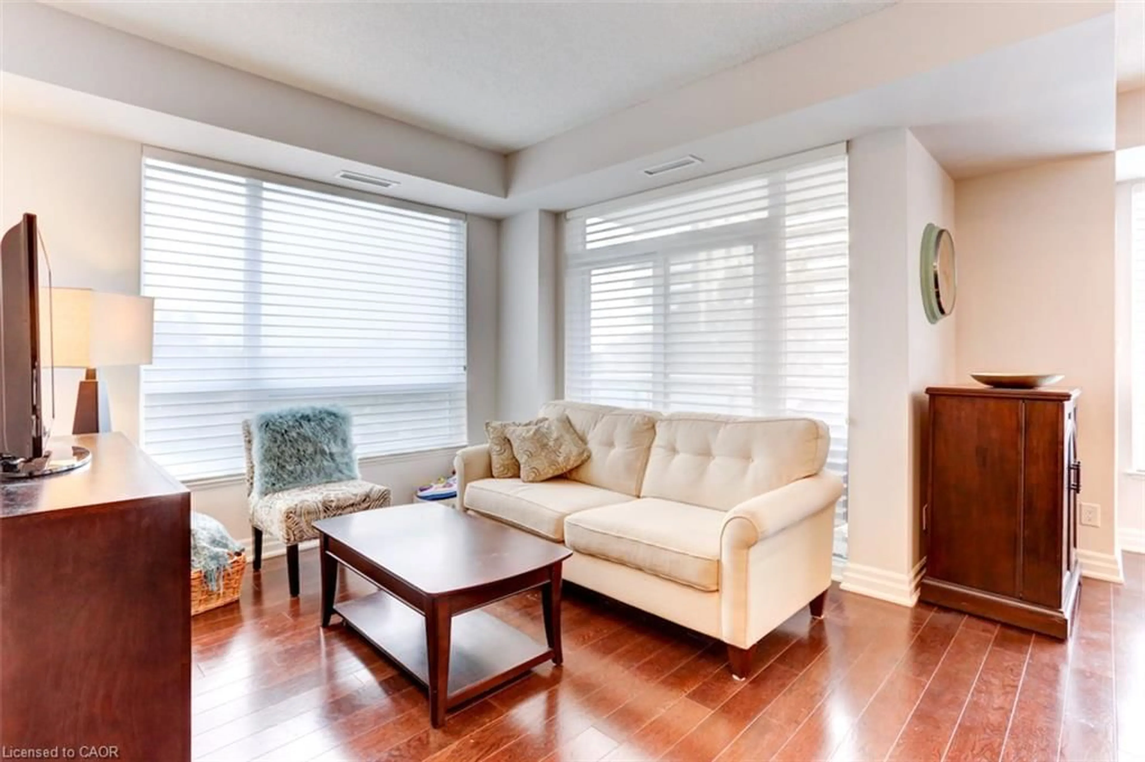 Living room with furniture, wood/laminate floor for 17 Ruddington Dr #402, North York Ontario M2K 0A8