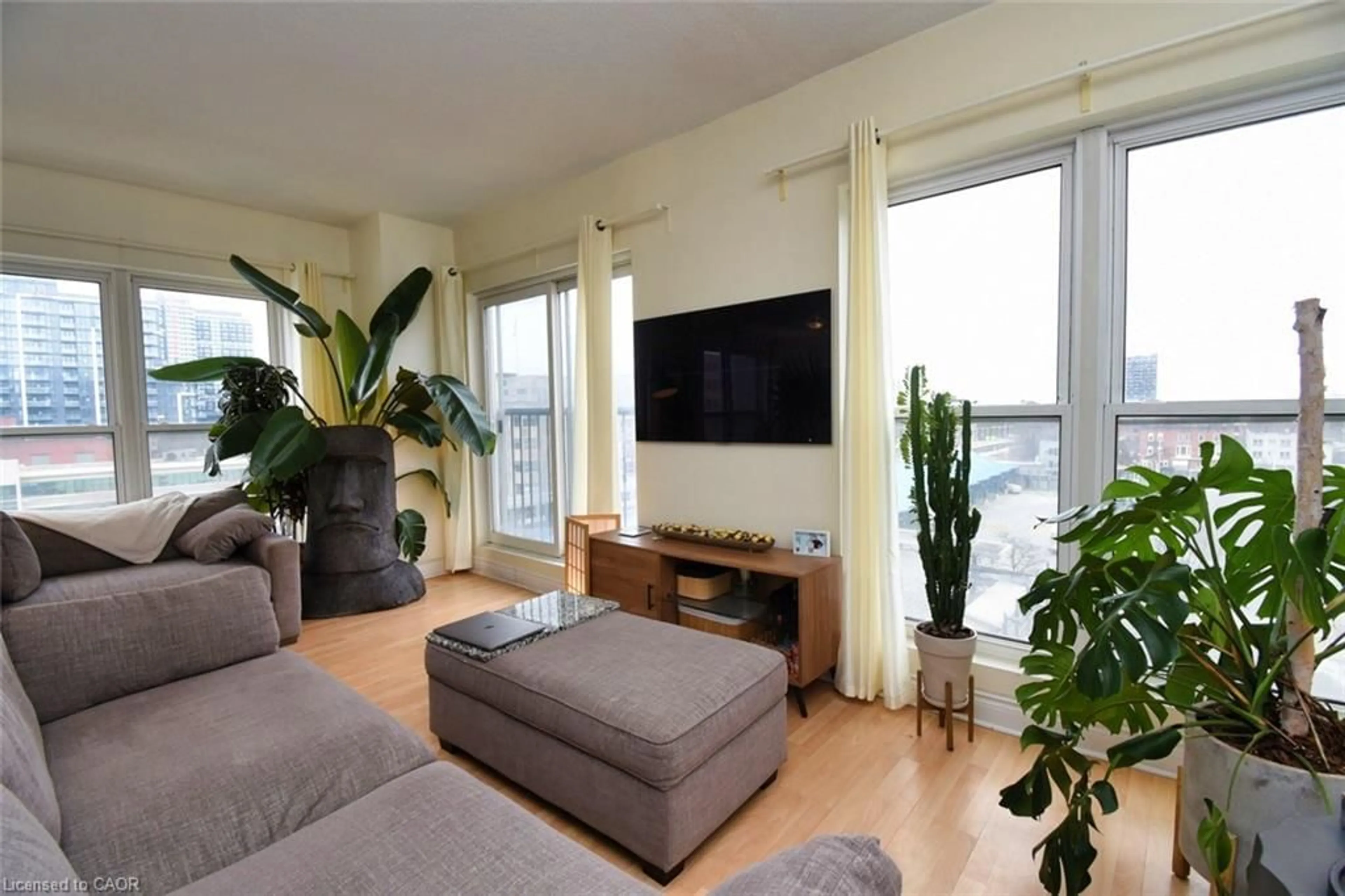 Living room with furniture, wood/laminate floor for 135 James St #502, Hamilton Ontario L8P 2Z6