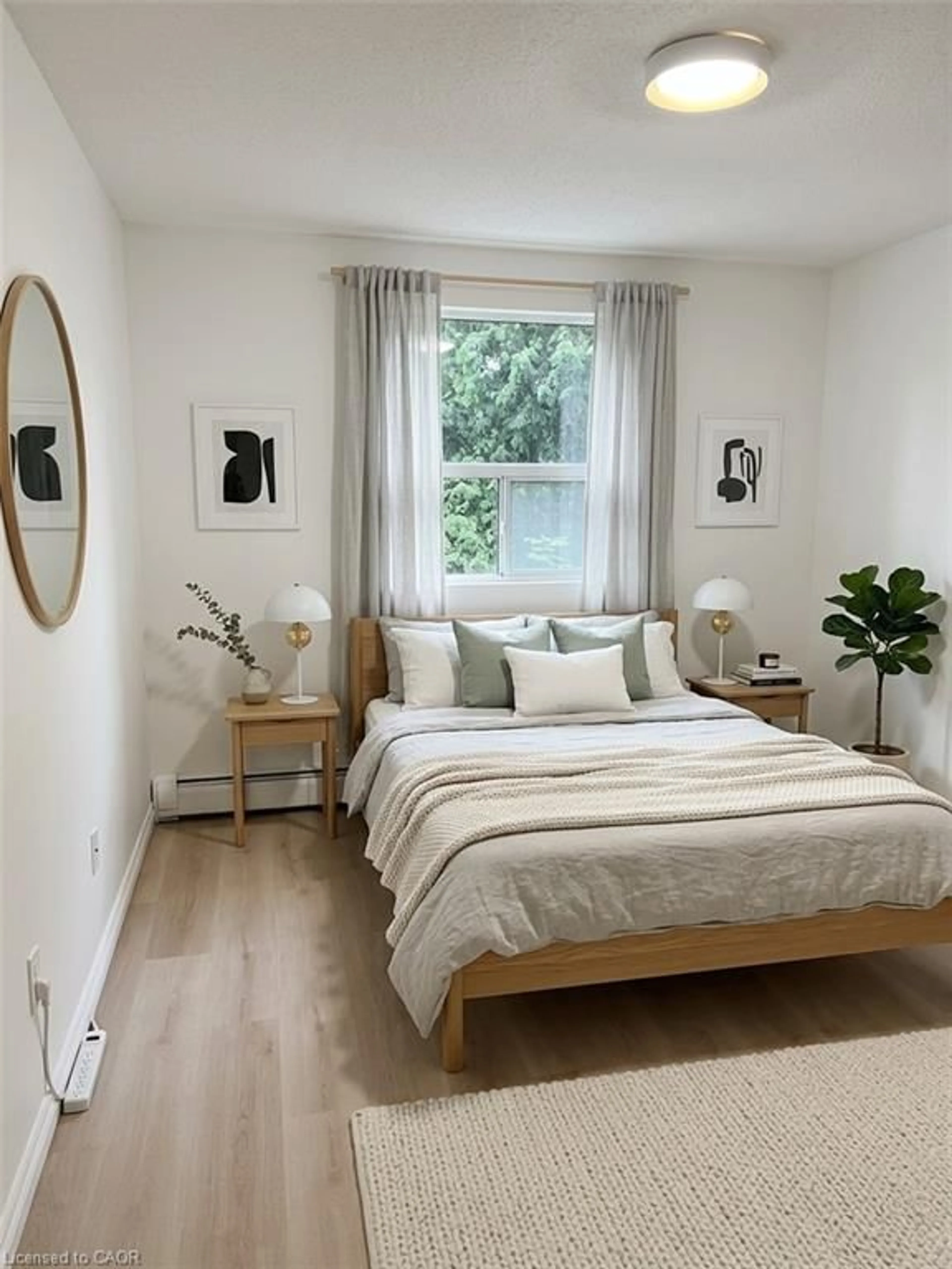 Bedroom with bed, wood/laminate floor for 793 Colborne St #114, Brantford Ontario N3S 7J3