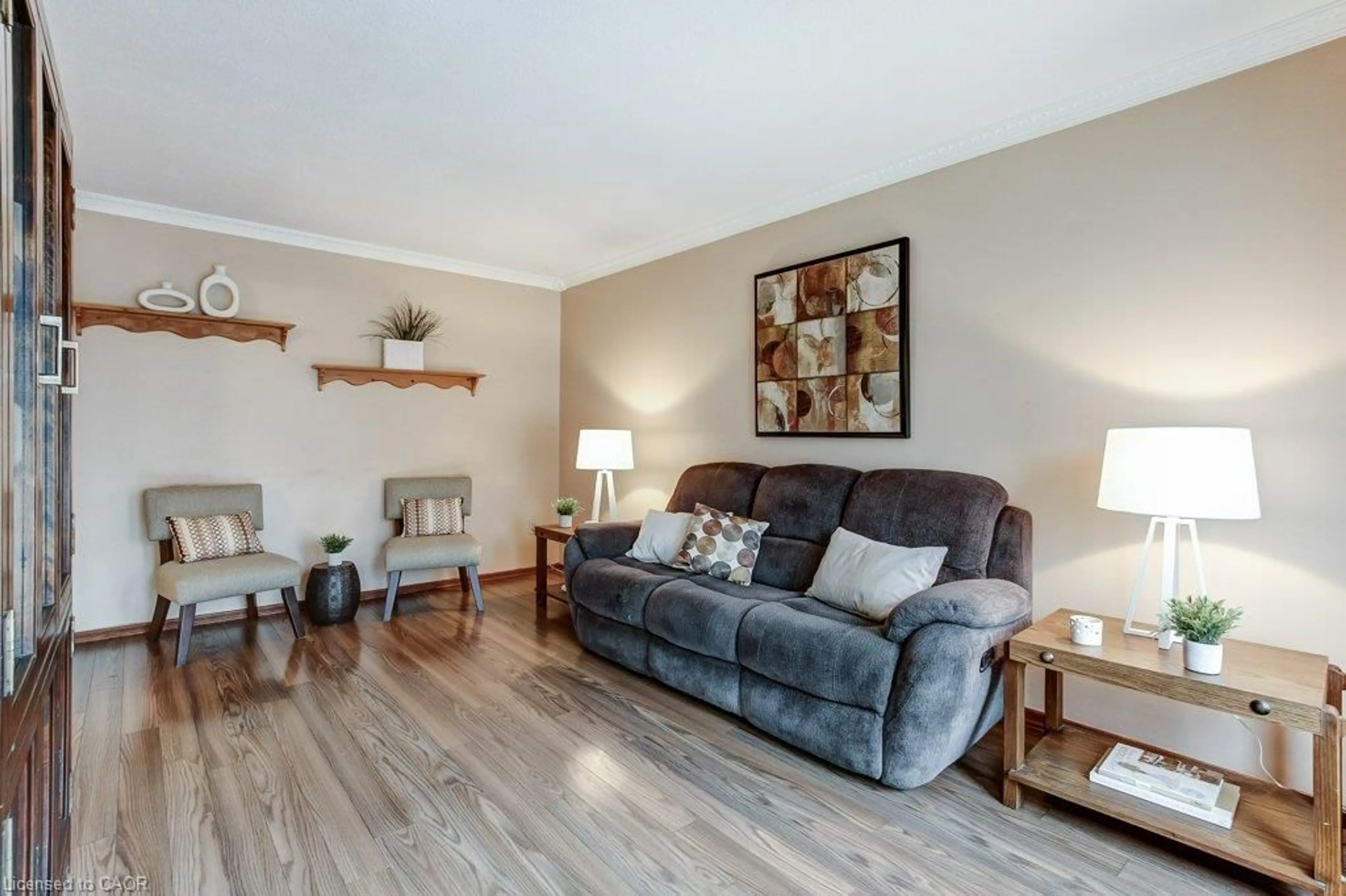 Living room with furniture, wood/laminate floor for 511 Rennie St, Hamilton Ontario L8H 3P6