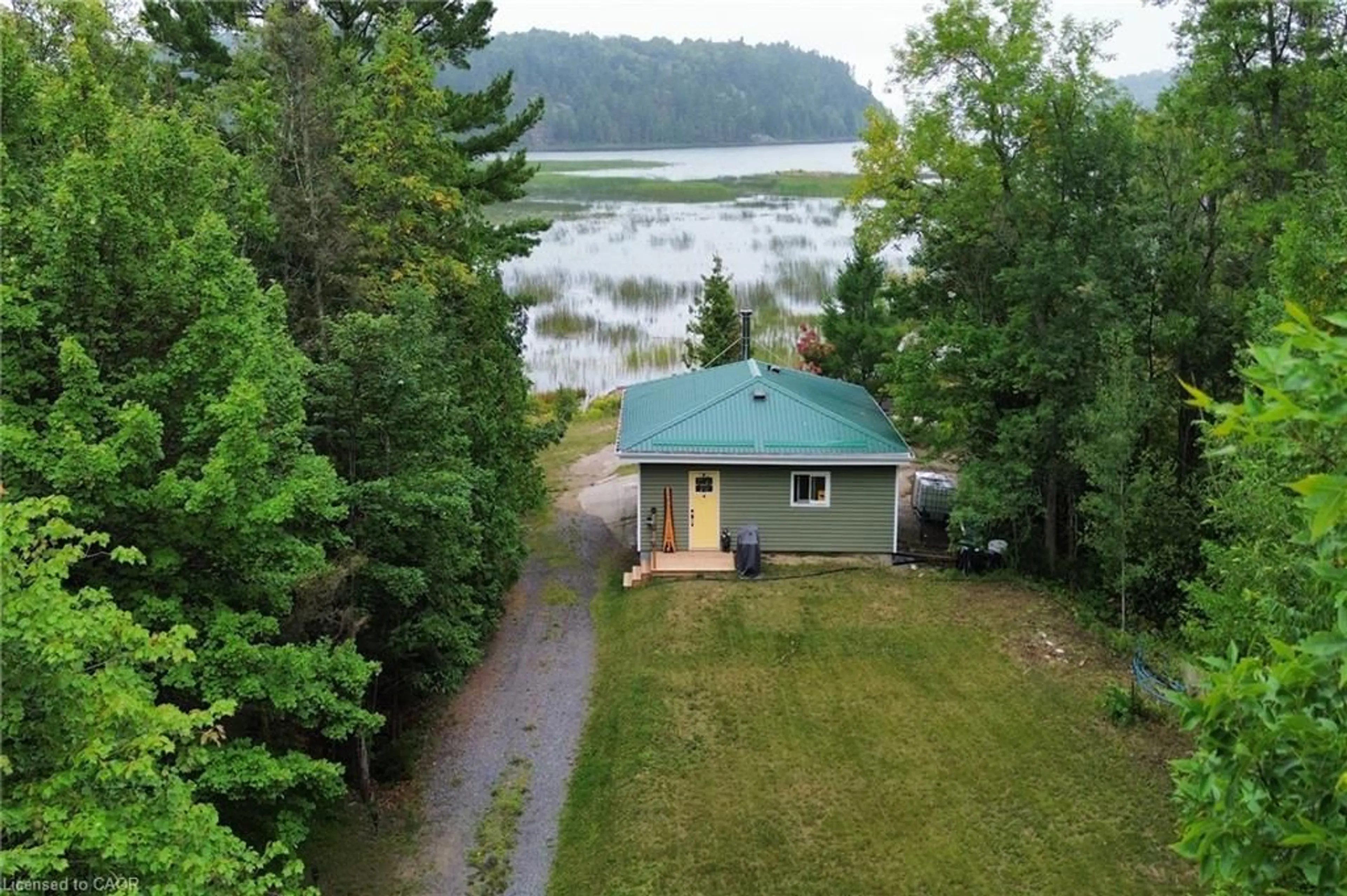 A pic from outside/outdoor area/front of a property/back of a property/a pic from drone, water/lake/river/ocean view for 354 Brennan Harbour Rd, Spanish Ontario P0P 2A0