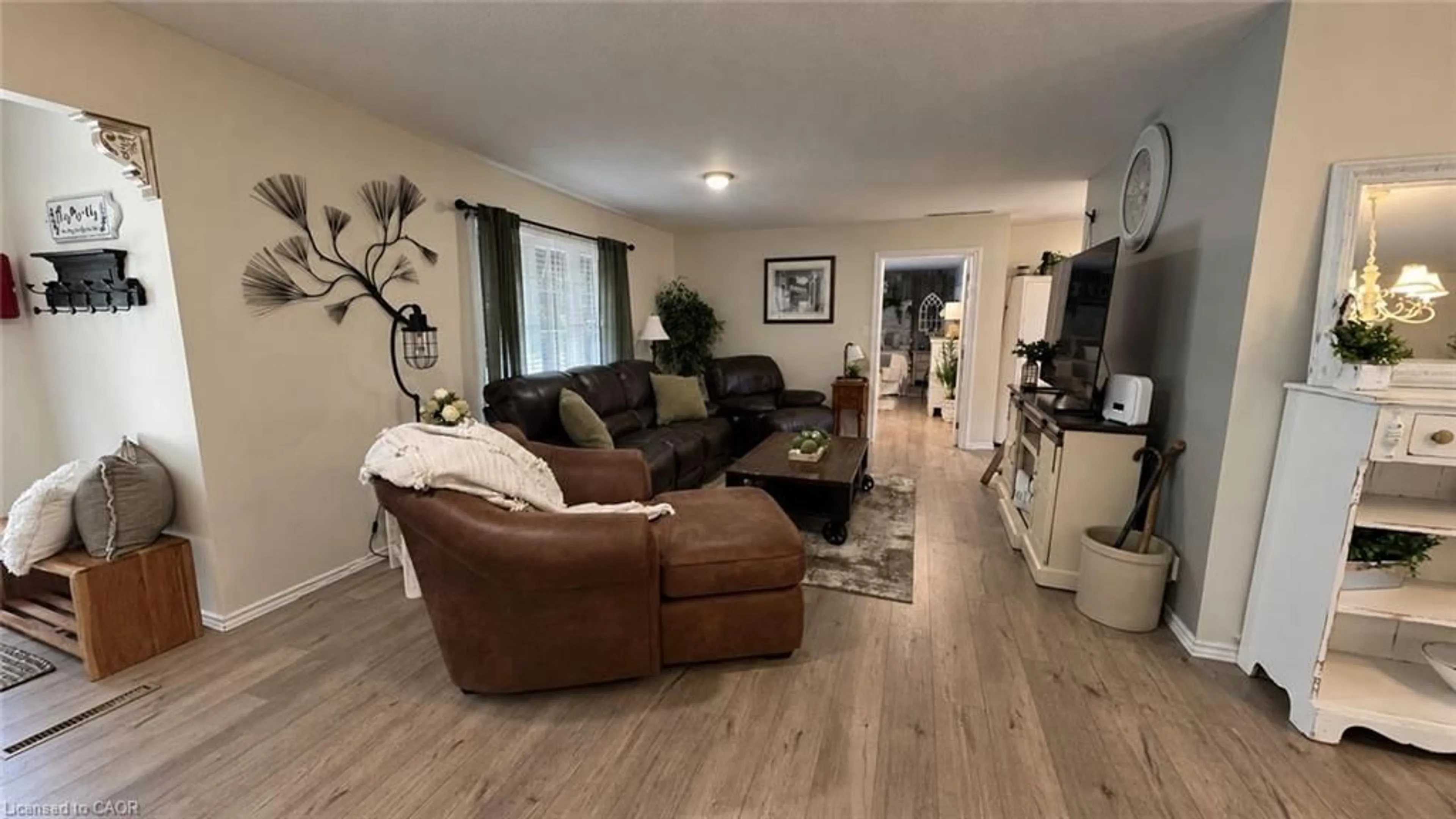 Living room with furniture, wood/laminate floor for 22815 Eastlawn Rd, Chatham Ontario N7M 5J4