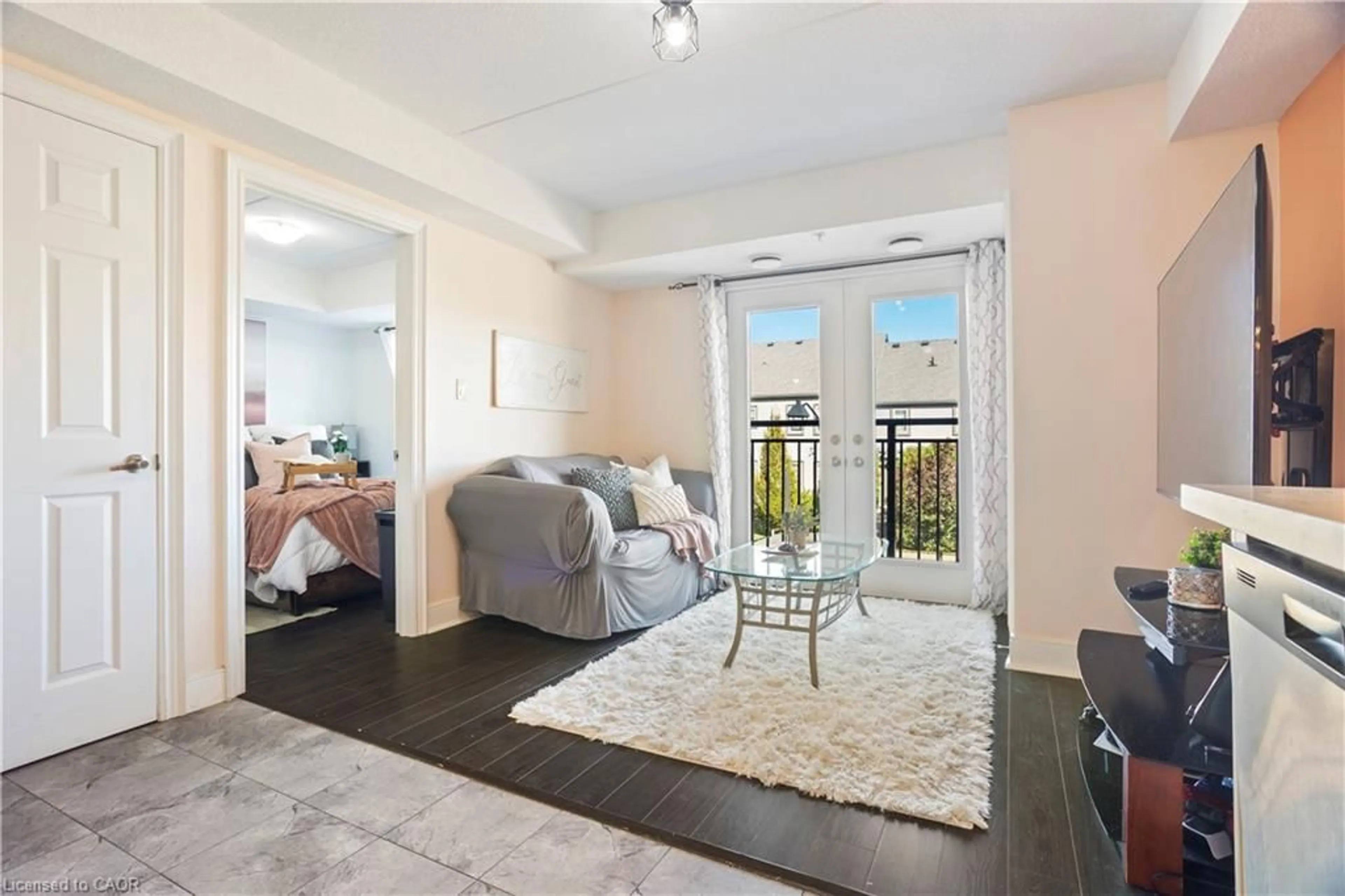 Living room with furniture, wood/laminate floor for 64 Frederick Dr #204, Guelph Ontario N1L 0P3