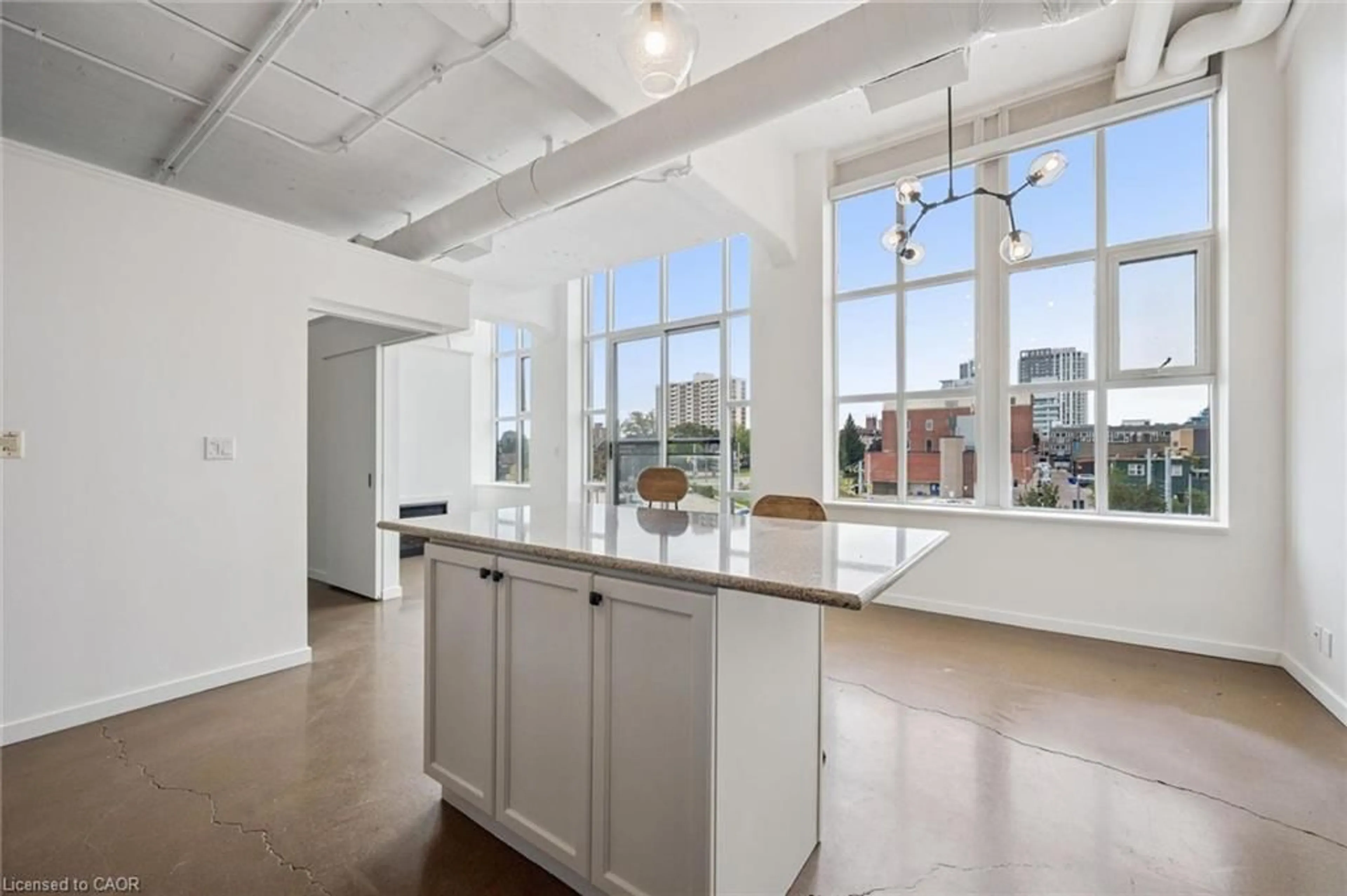 Open concept kitchen, cement floor for 404 King St #317, Kitchener Ontario N2G 4Z9