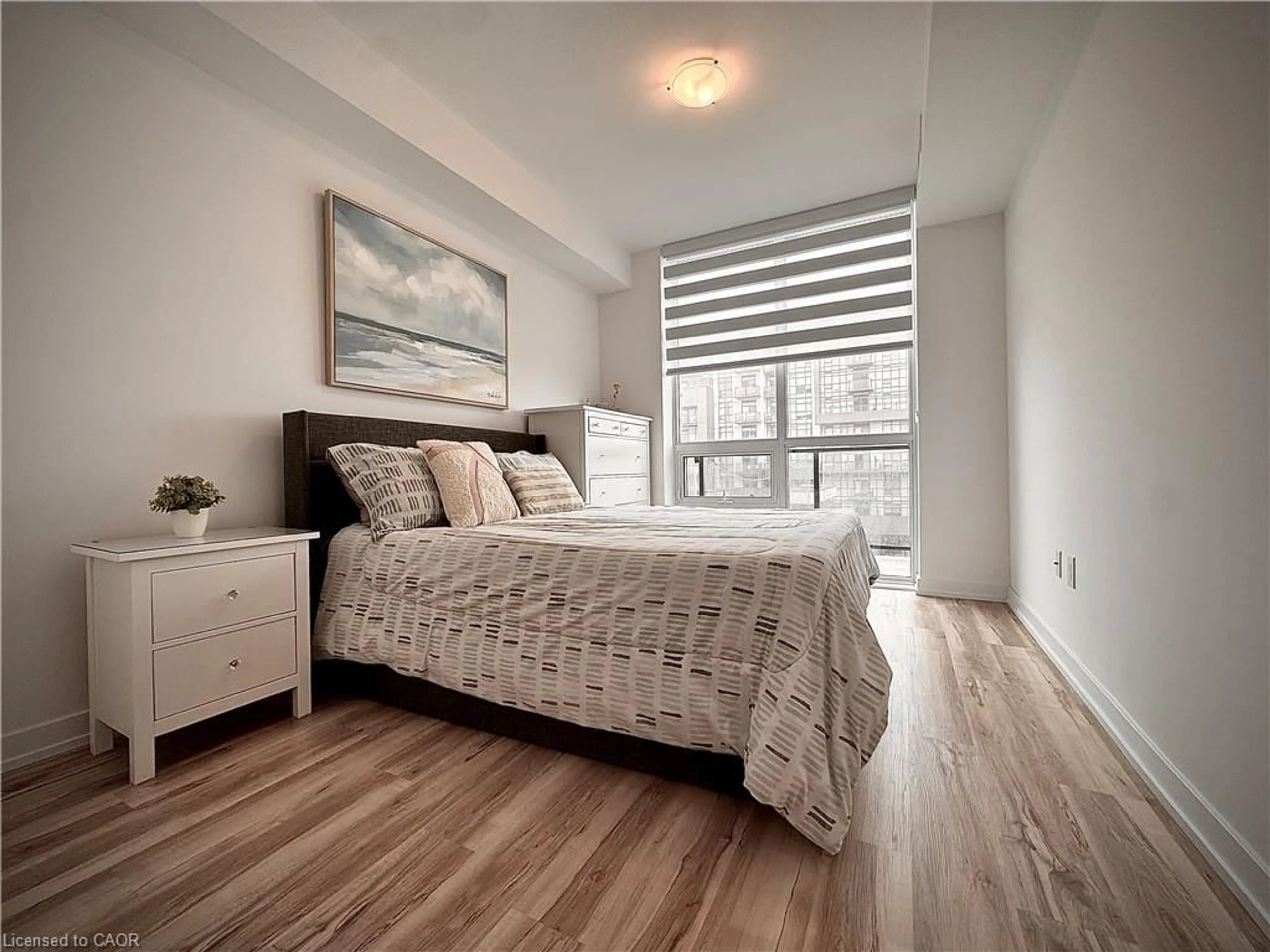 Bedroom with bed, wood/laminate floor for 460 Dundas St #709, Waterdown Ontario L8B 2A5