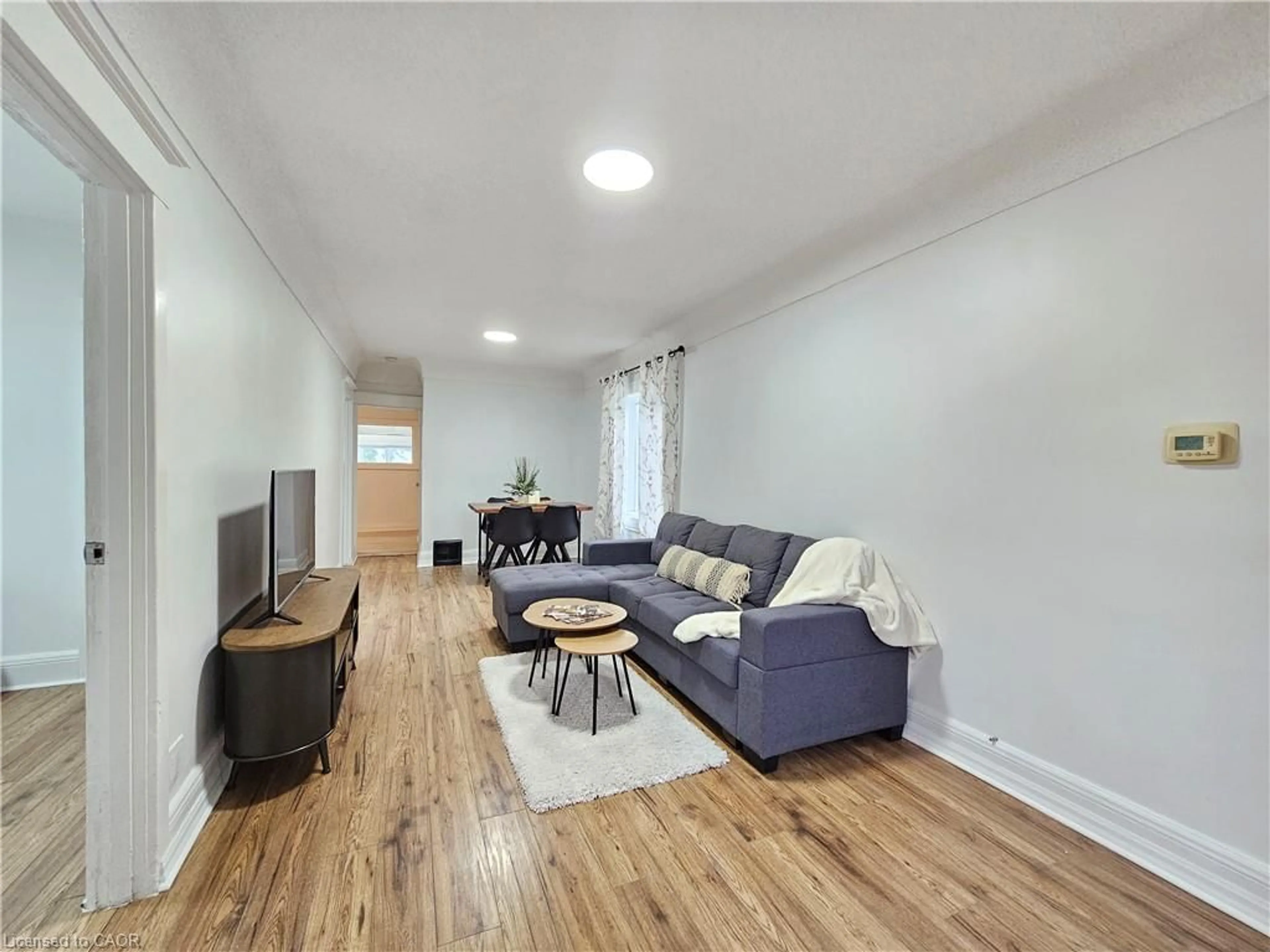 Living room with furniture, wood/laminate floor for 643 Upper Wellington St, Hamilton Ontario L9A 3R2