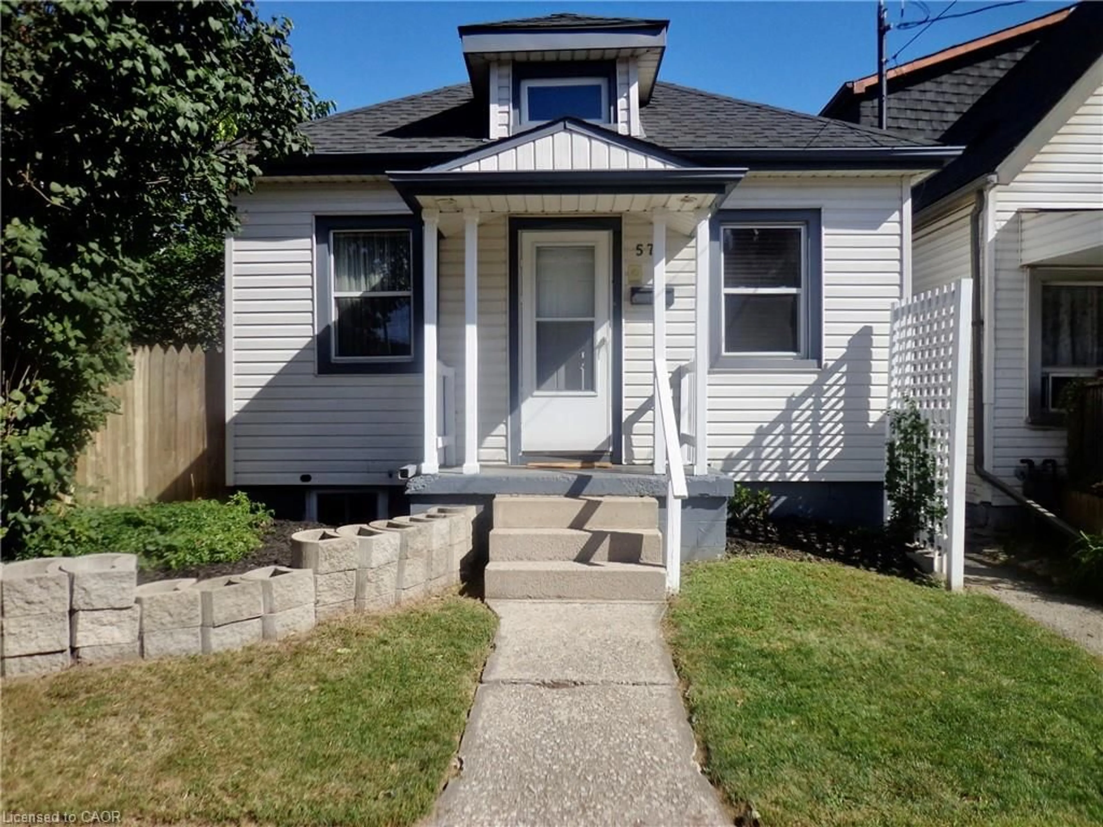 Home with vinyl exterior material, street for 57 Harrison Ave, Hamilton Ontario L8N 1N9