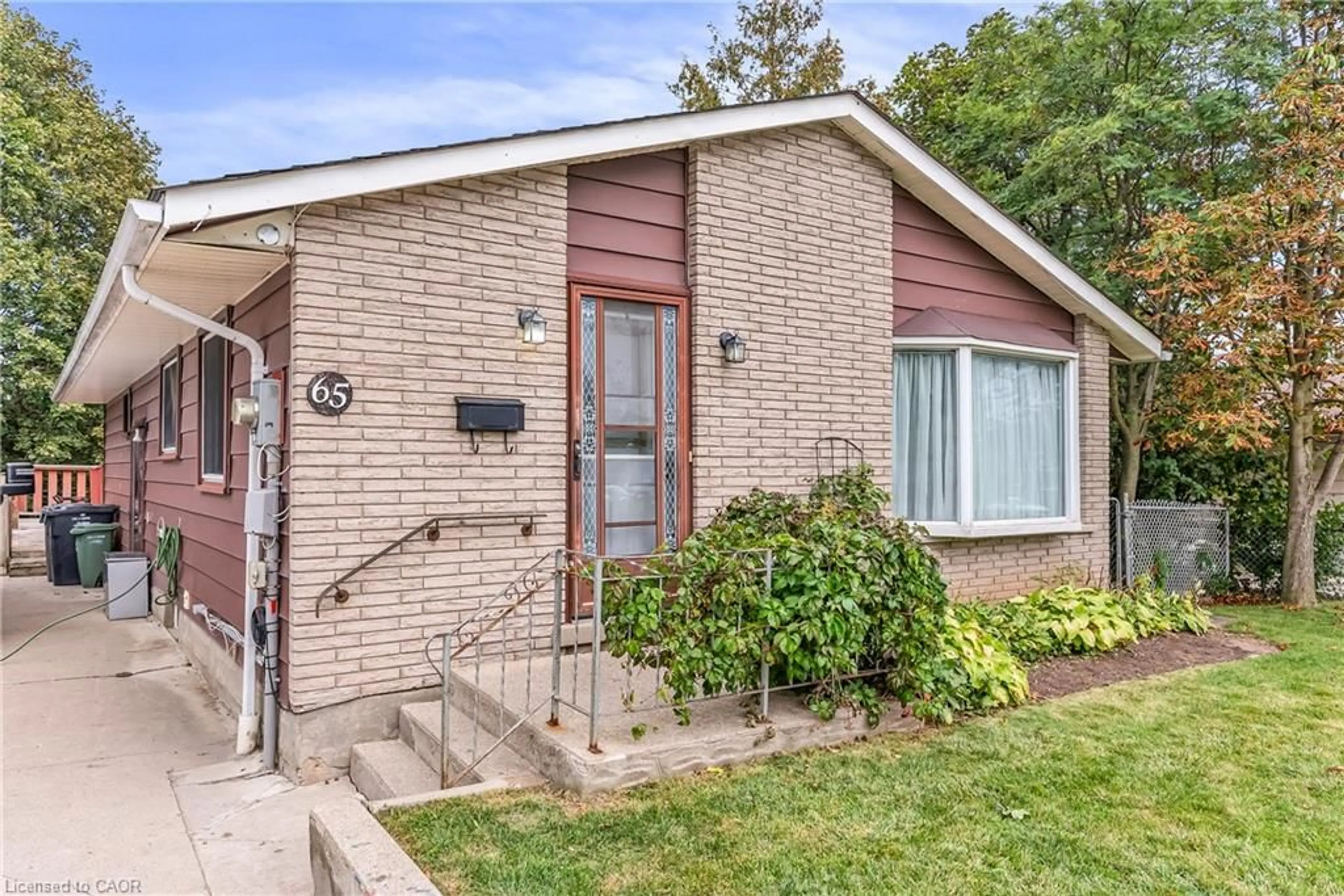 Home with brick exterior material, street for 65 Mountford Dr, Guelph Ontario N1E 6E7