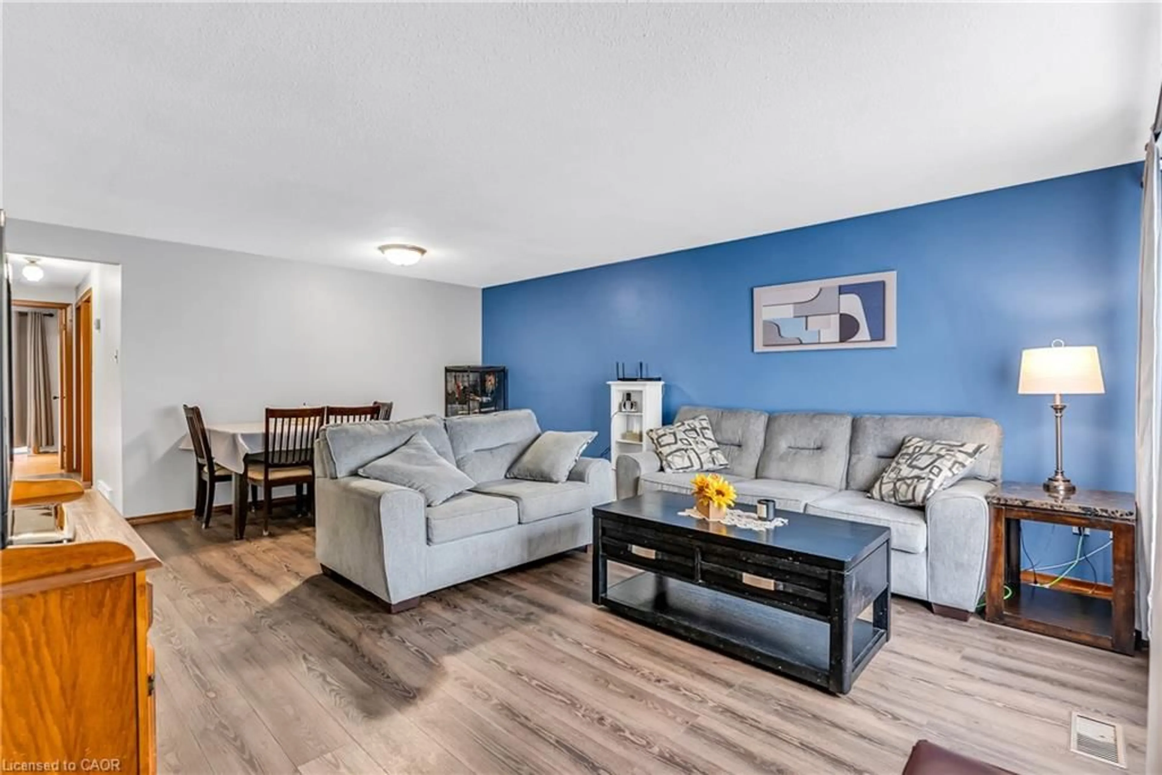 Living room with furniture, wood/laminate floor for 65 Mountford Dr, Guelph Ontario N1E 6E7