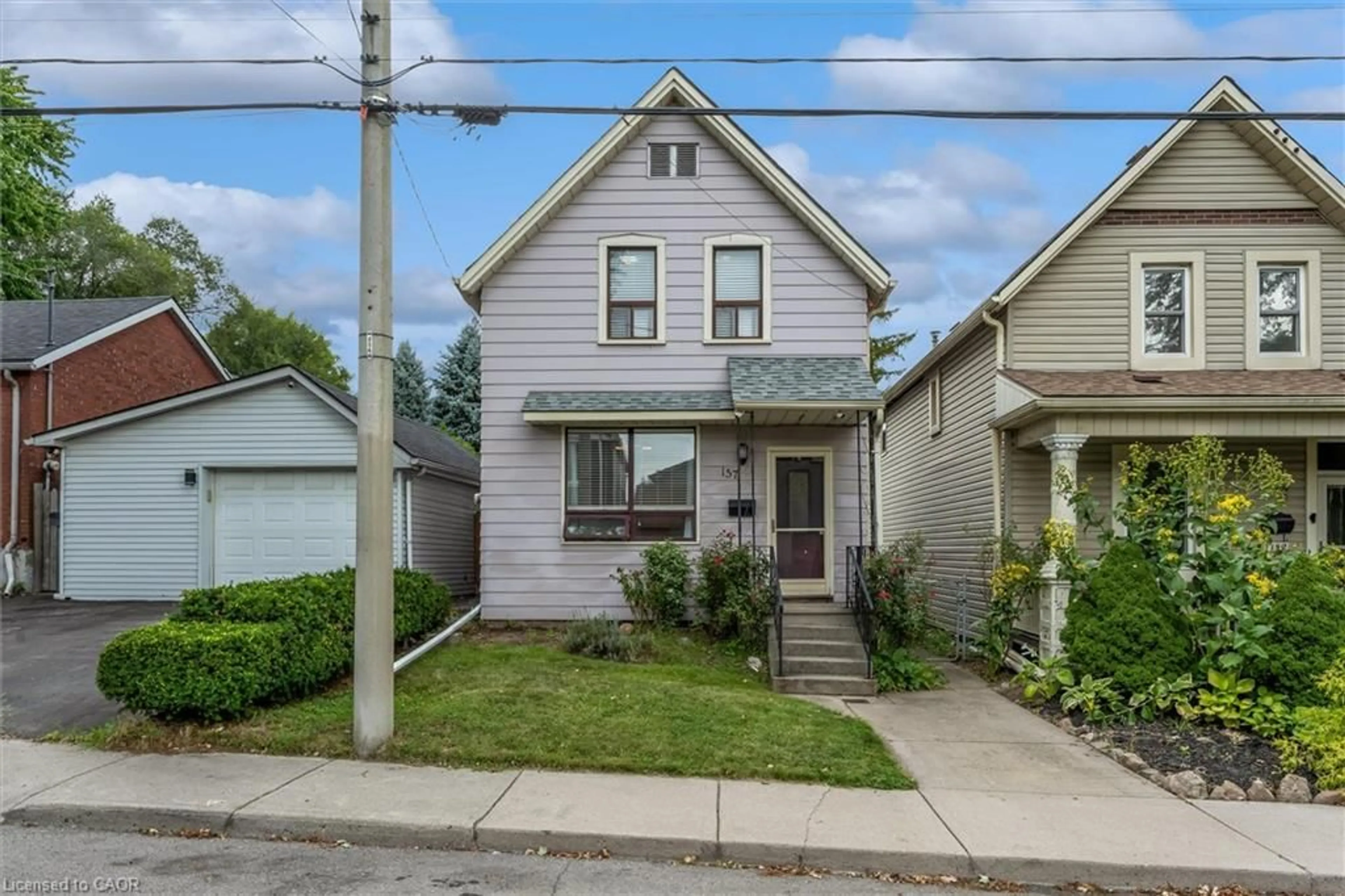 Home with vinyl exterior material, street for 157 Macaulay St, Hamilton Ontario L8L 3X5