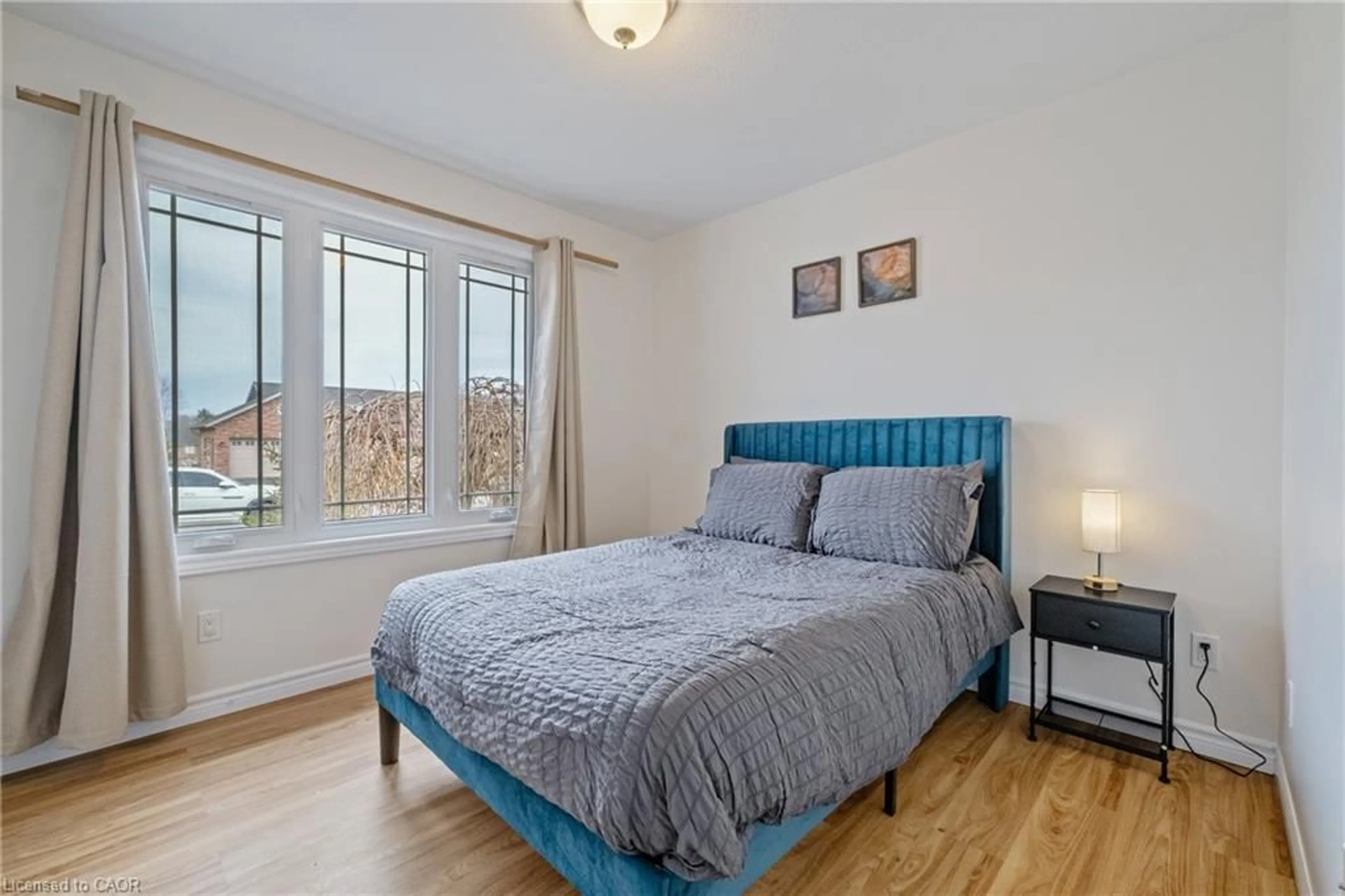 Bedroom with bed, wood/laminate floor for 401 Carling Terr, Wingham Ontario N0G 2W0
